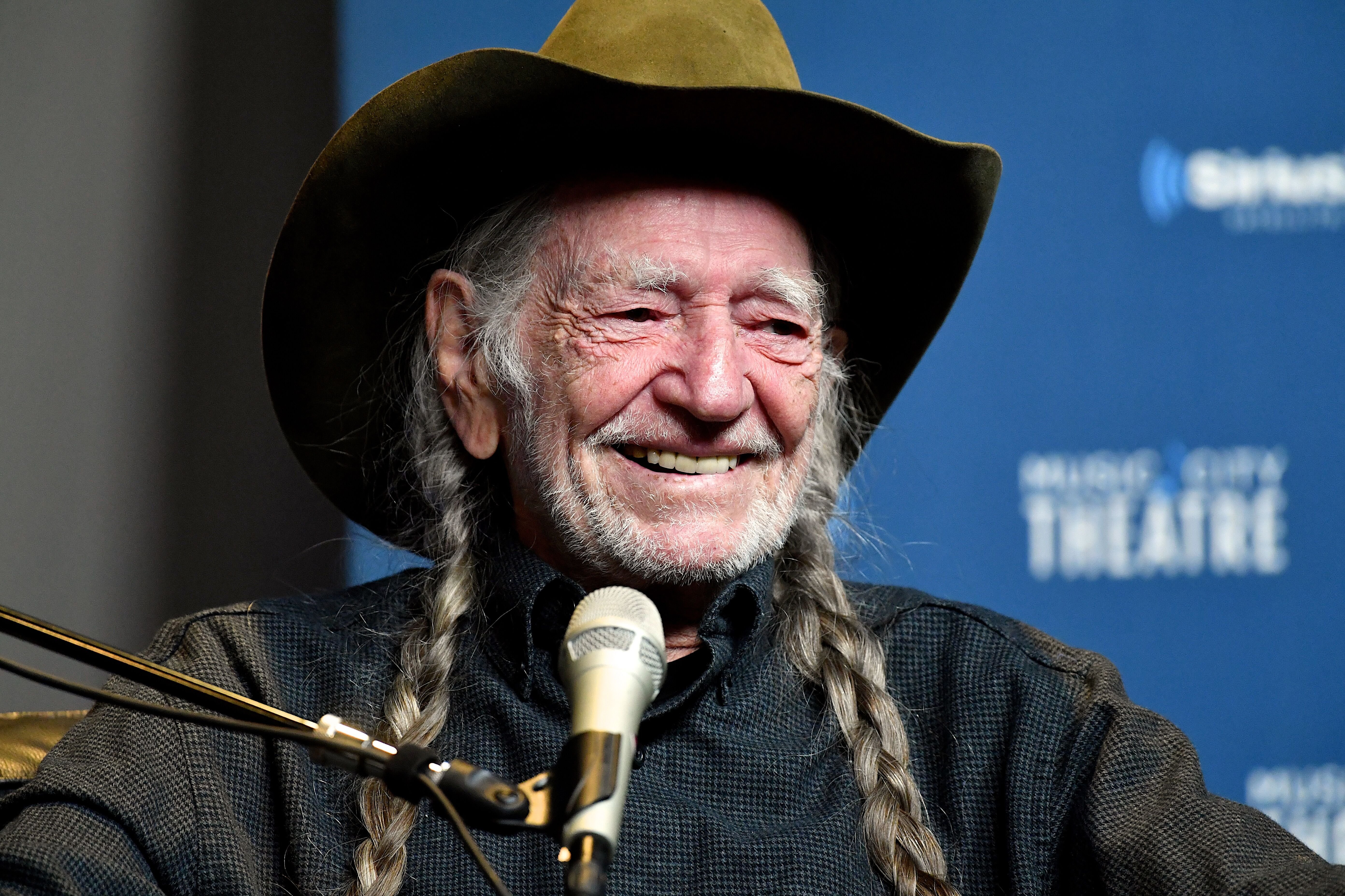 Willie Nelson speaks onstage at his album premiere. | Source: Getty Images