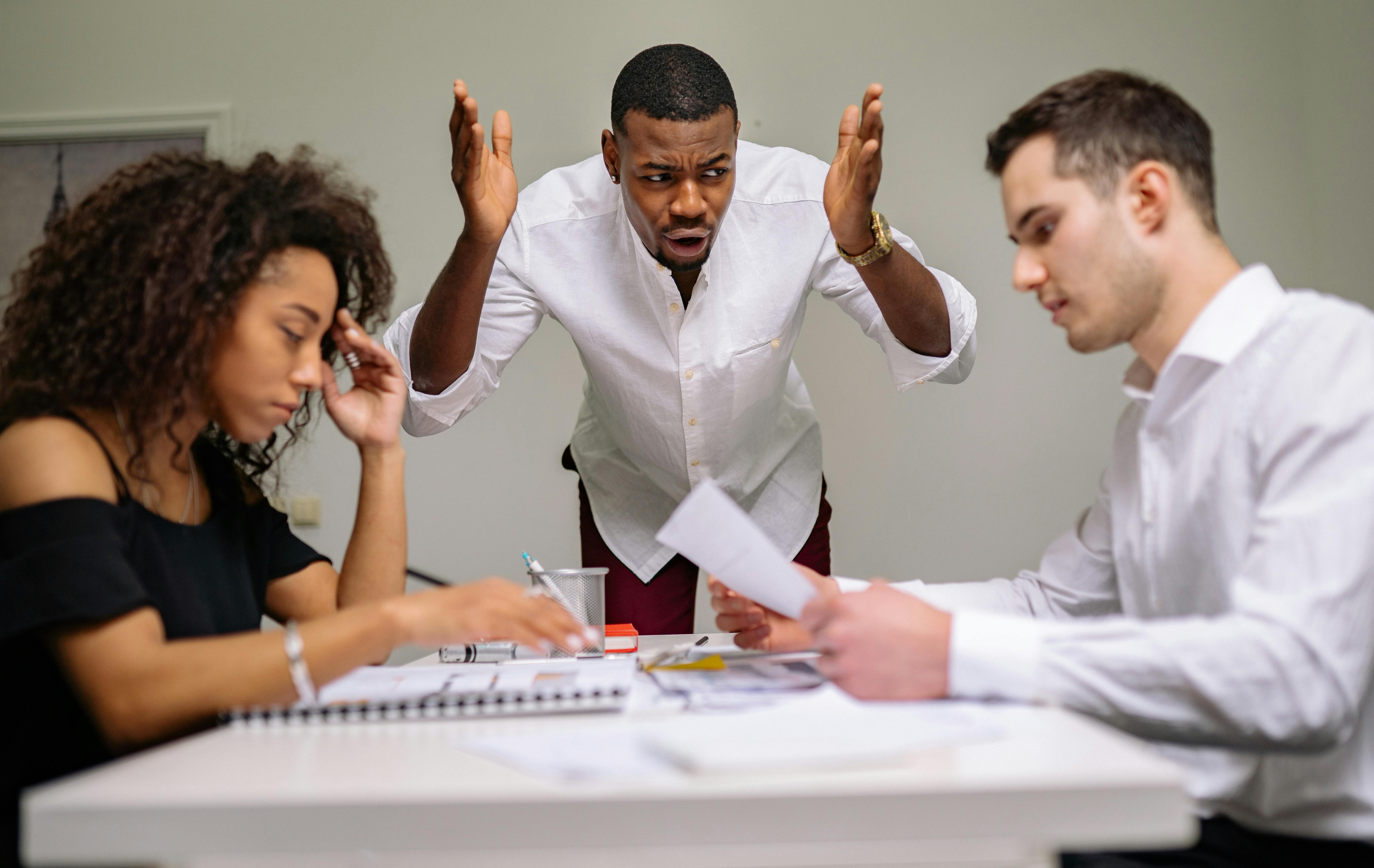 A man yelling at two other people | Source: Pexels