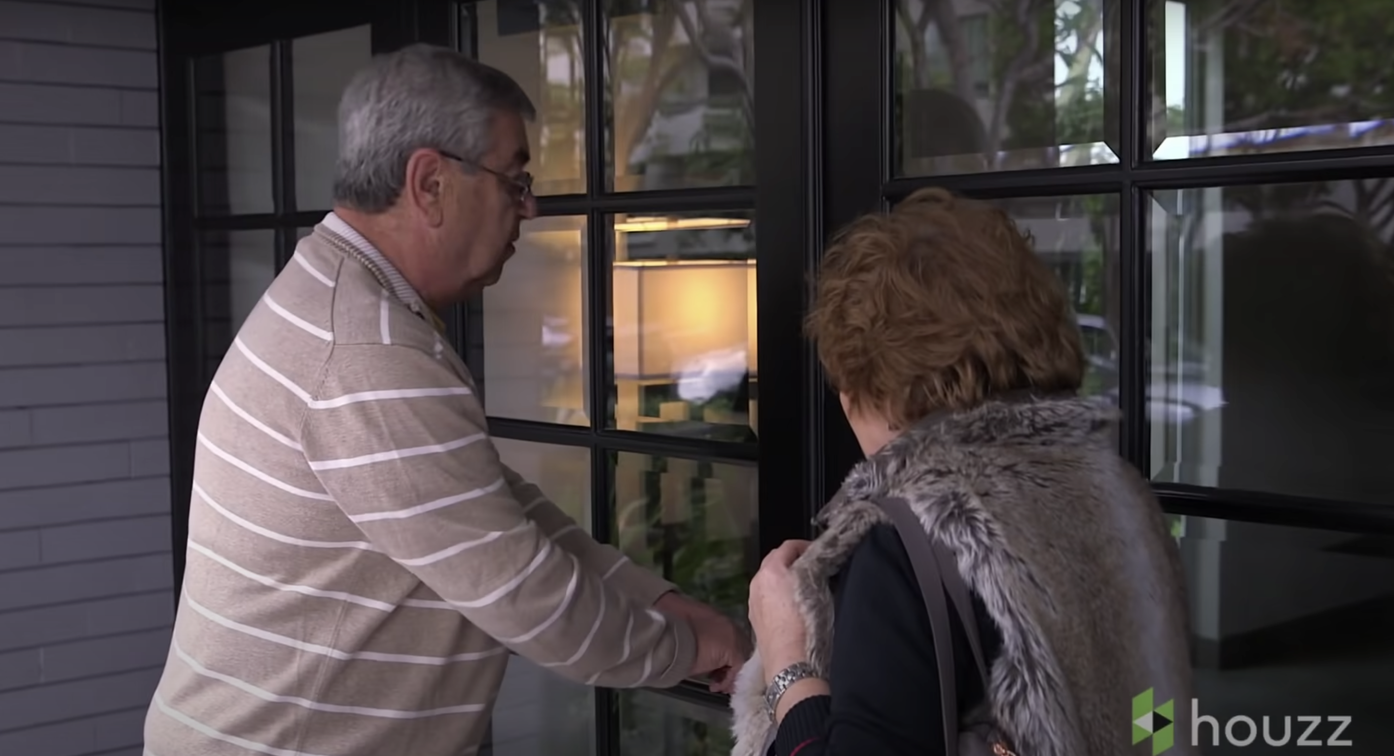 Mila Kunis' parents, Mark and Elvira Kunis, are pictured outside the condo | Source: Youtube.com/HouzzTV