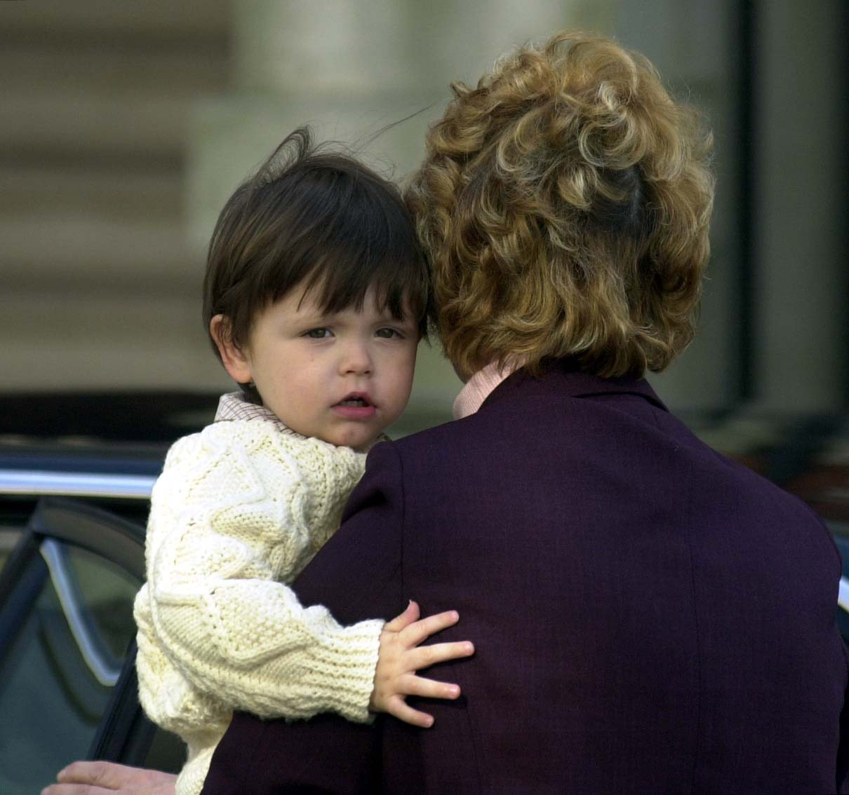 Dylan is carried into Morgans Hotel, Swansea, by his grandmother Pat during a visit to Wales | Source: Getty Images