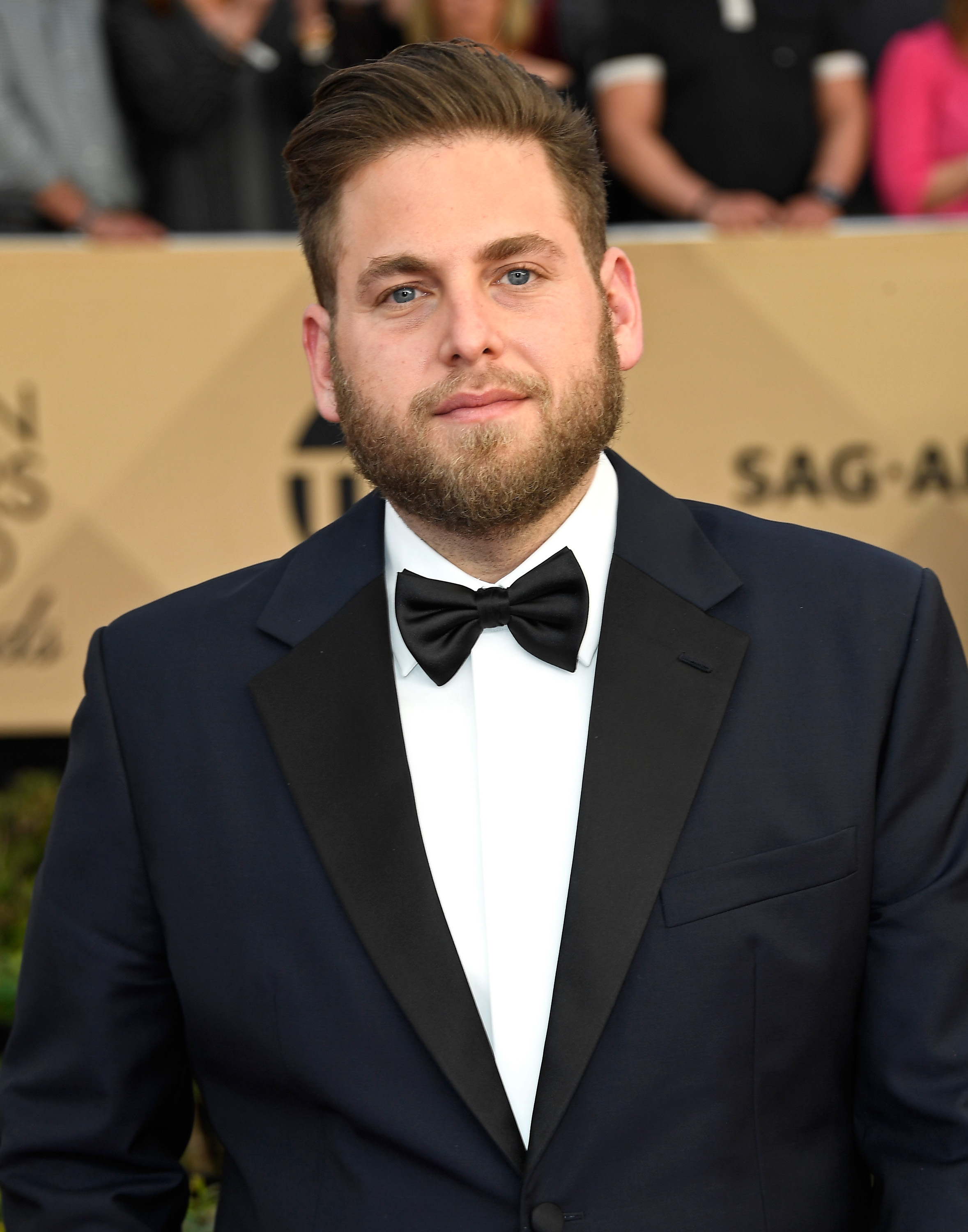 Jonah Hill stepped out for the 23rd Annual Screen Actors Guild Awards at the Shrine Auditorium in Los Angeles on January 29, 2017. Wearing a dark tuxedo with a crisp white shirt and black bow tie, the actor sported neatly styled hair and a full beard as he posed for photographers. His noticeably leaner face and frame reflected another stage in his years-long physical transformation.