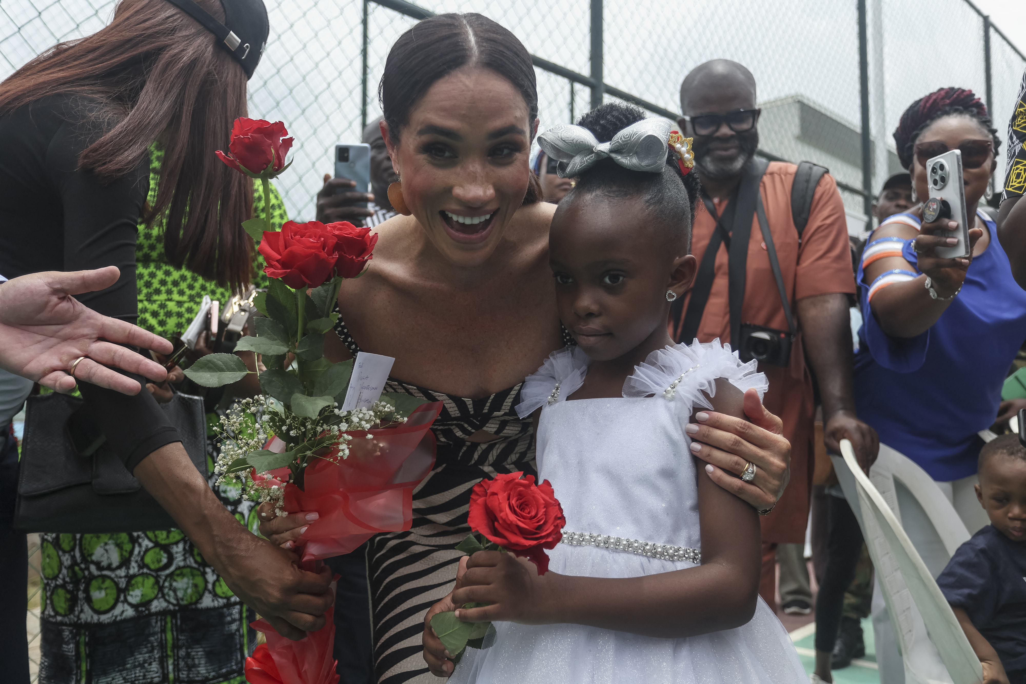 Meghan Markle and a young local girl at a sitting volleyball match at Nigeria Unconquered, a local charity organisation in Abuja, Nigeria on May 11, 2024 | Source: Getty Images