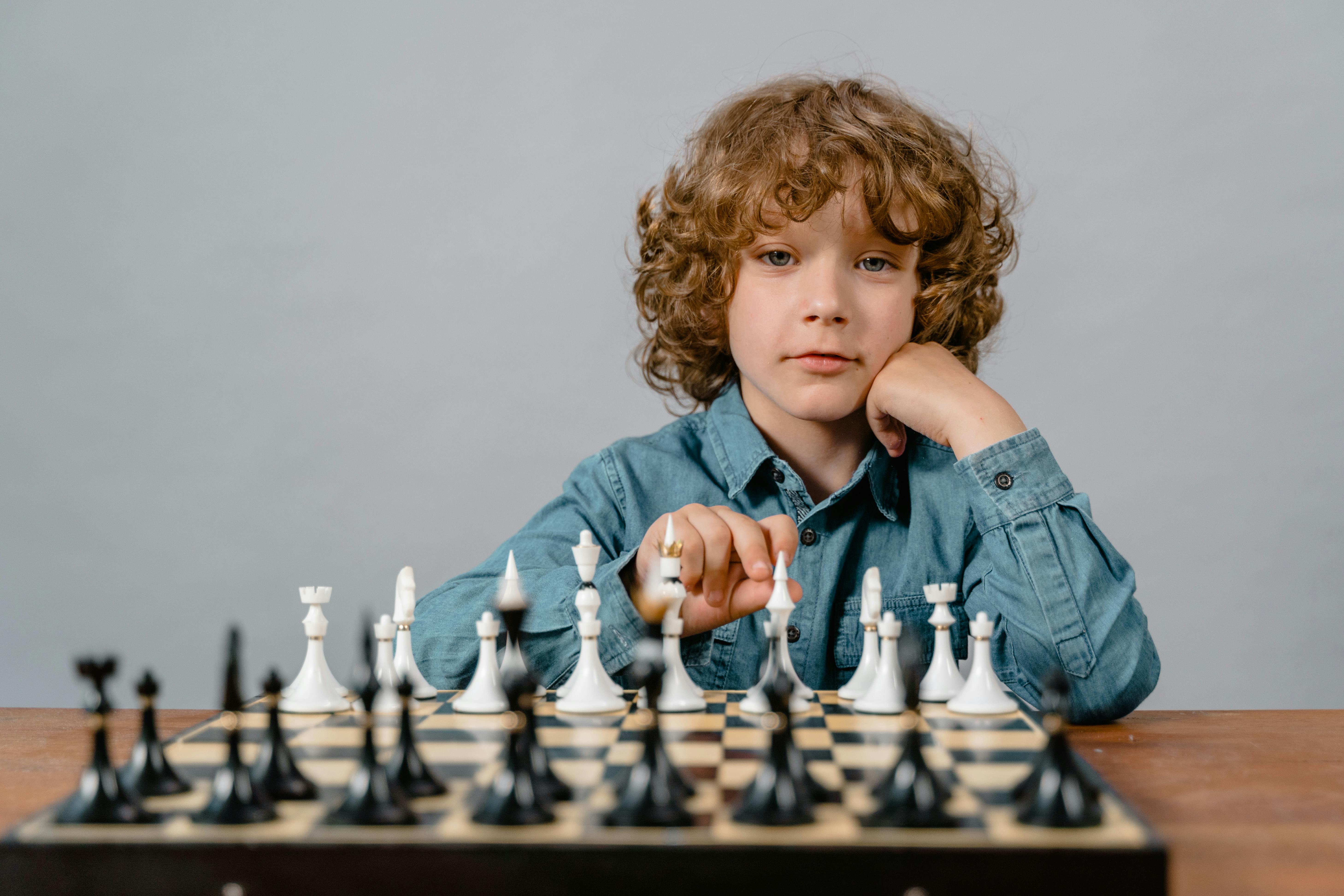 A boy looking over a chess board | Source: Pexels