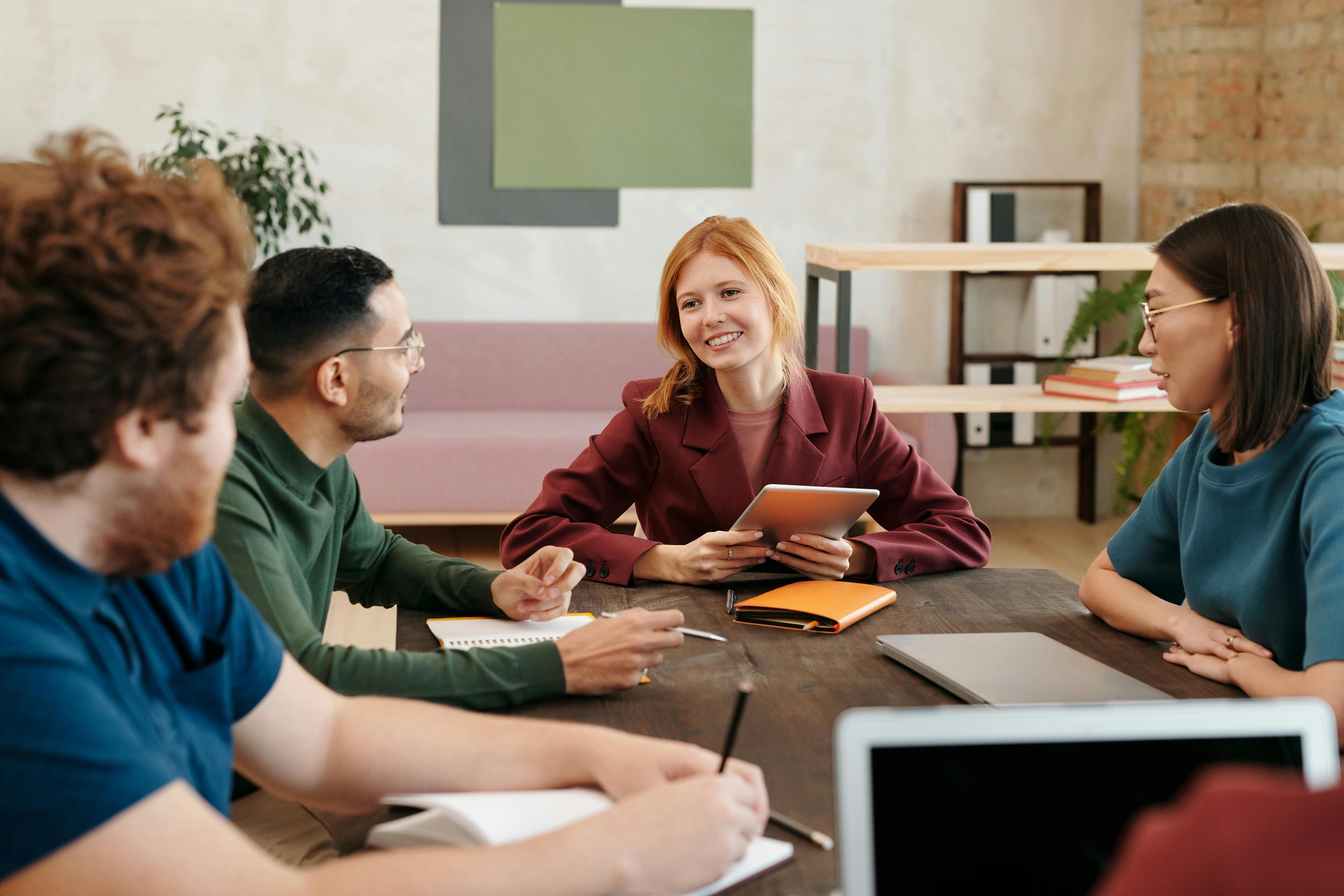 Co-workers around a table | Source: Pexels