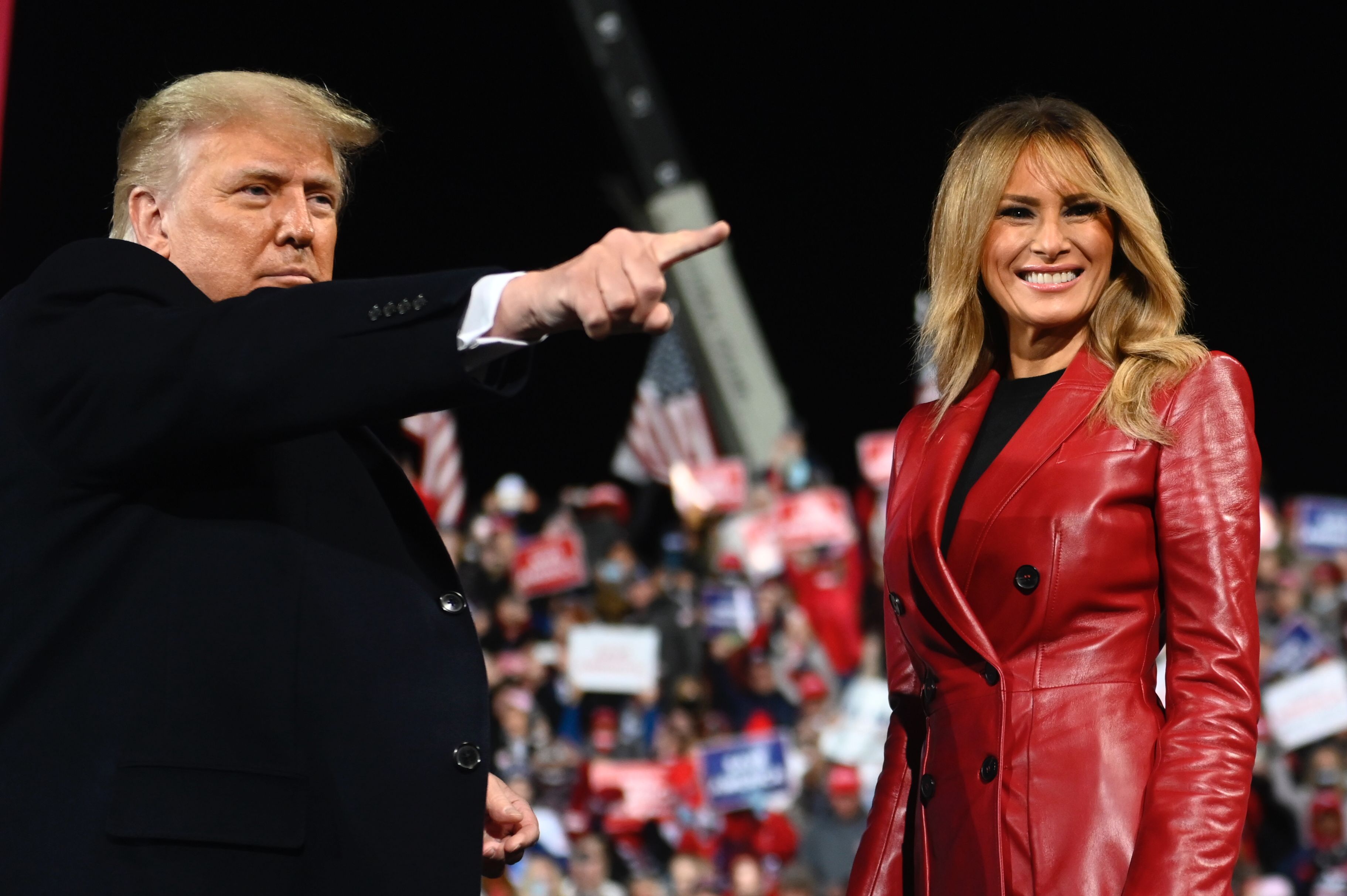 Donald Trump stands with Melania Trump at the end of a rally to support Republican Senate candidates at Valdosta Regional Airport in Valdosta, Georgia, on December 5, 2020 | Source: Getty Images