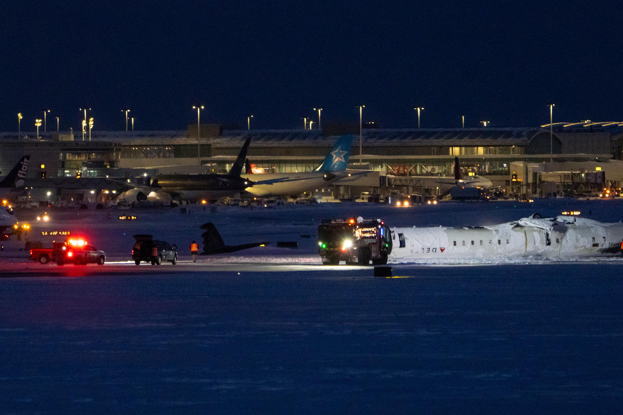 A Delta Airlines plane lies overturned after crashing earlier in the day at Toronto Pearson International Airport on February 17, 2025 | Source: Getty Images