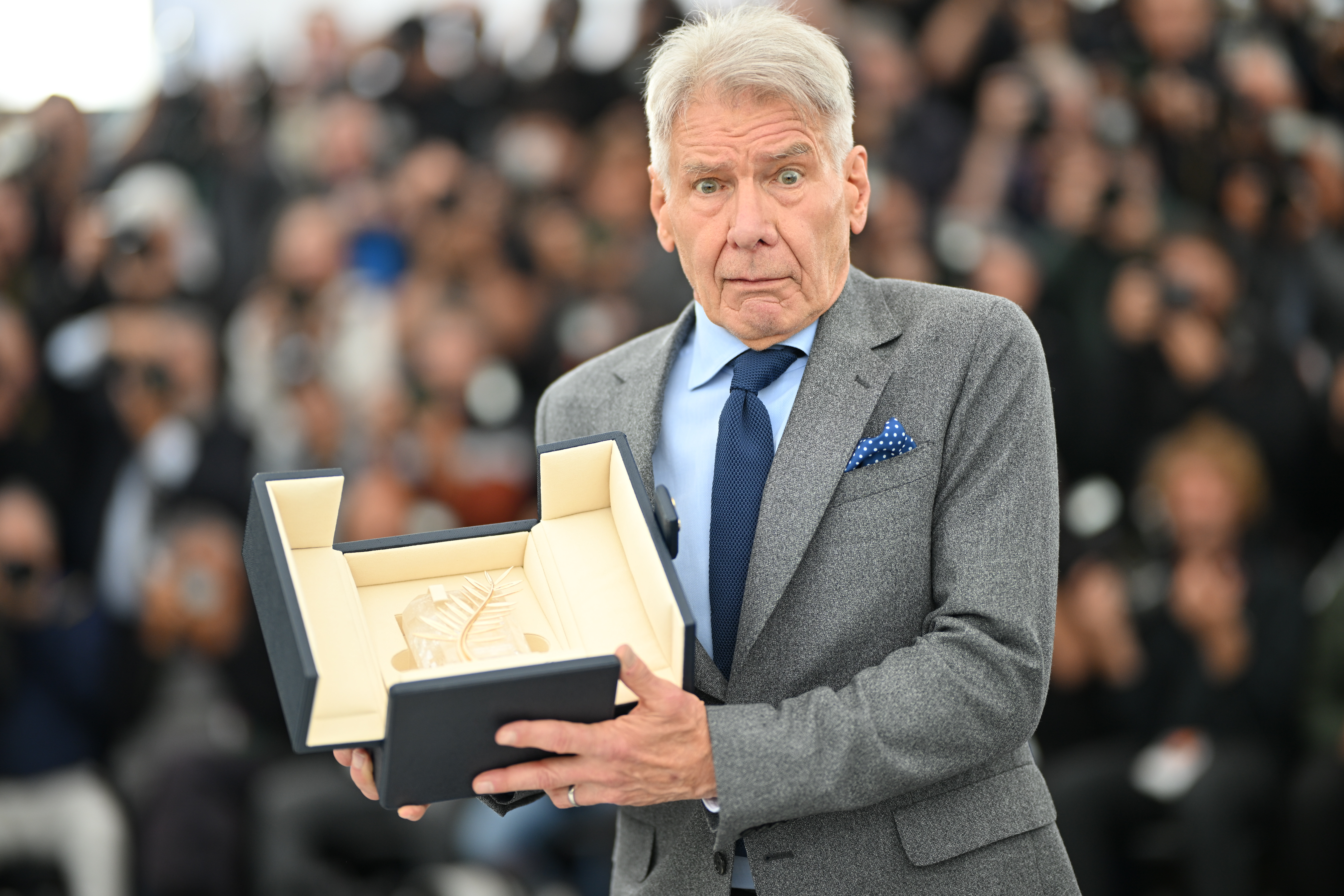 Harrison Ford shows the honorary Palme d'Or he received at the 76th annual Cannes film festival in Cannes, France on May 19, 2023| Source: Getty Images