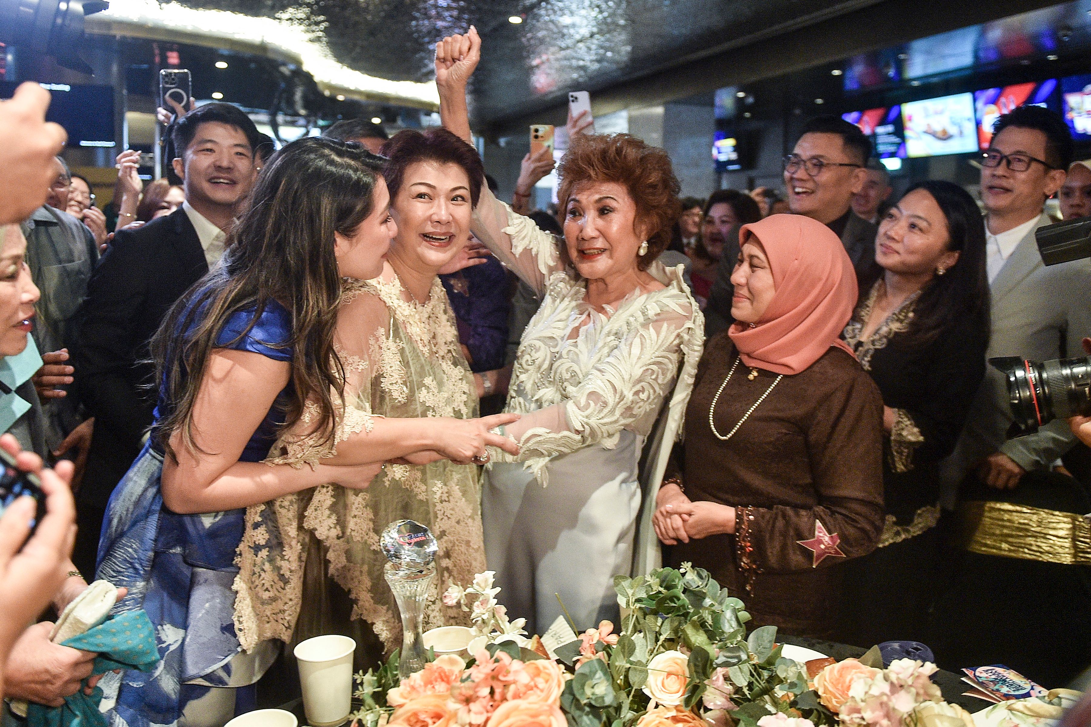 Janet Yeoh (centre R), mother of actress Michelle Yeoh, is pictured as she celebrates after her daughter won the award for Best Actress in a Leading Role at the 95th Academy Awards in Los Angeles, at an event in Kuala Lumpur on March 13, 2023 | Source: Getty Images