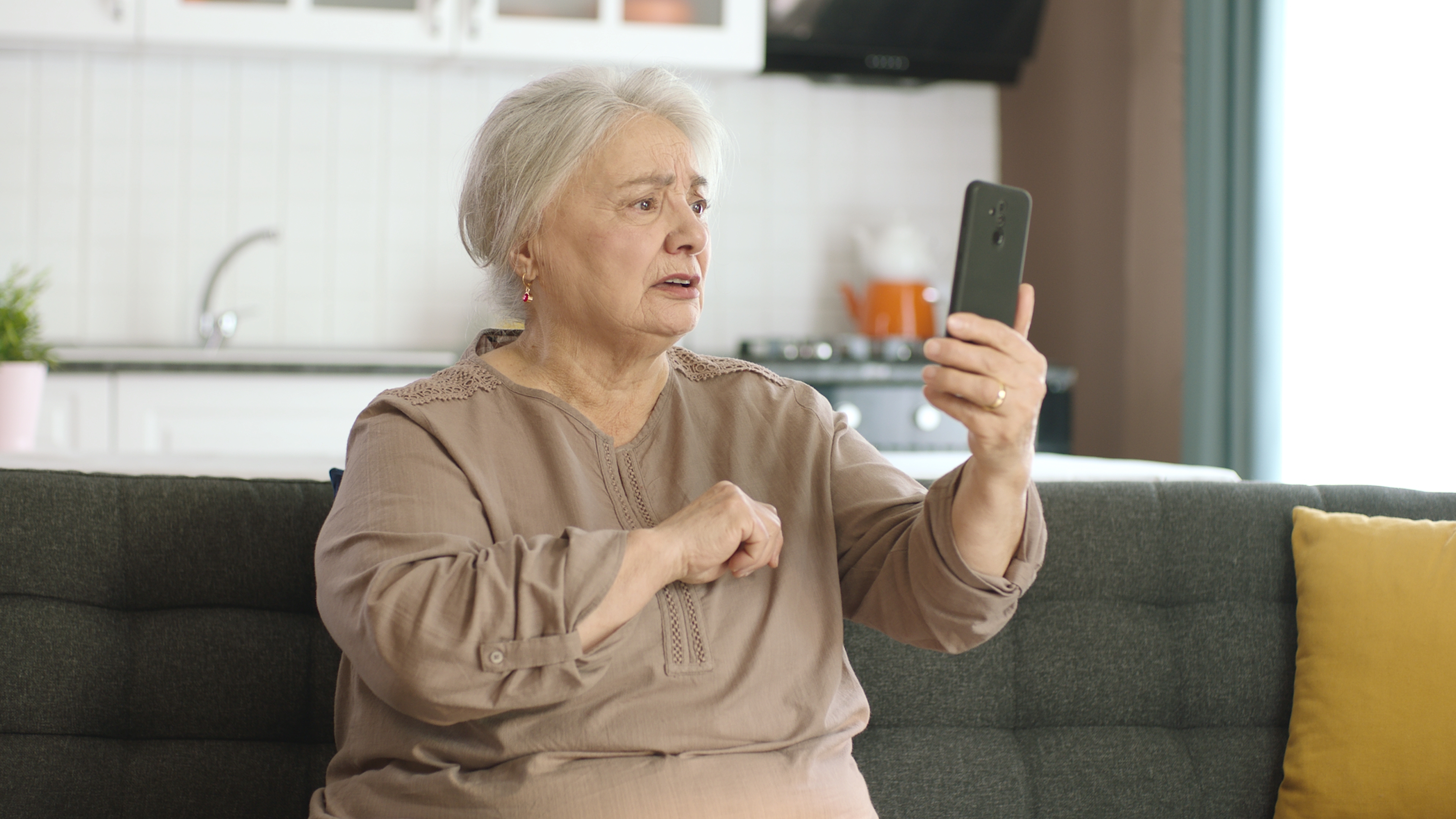 Angry older woman on looking at her phone | Source: