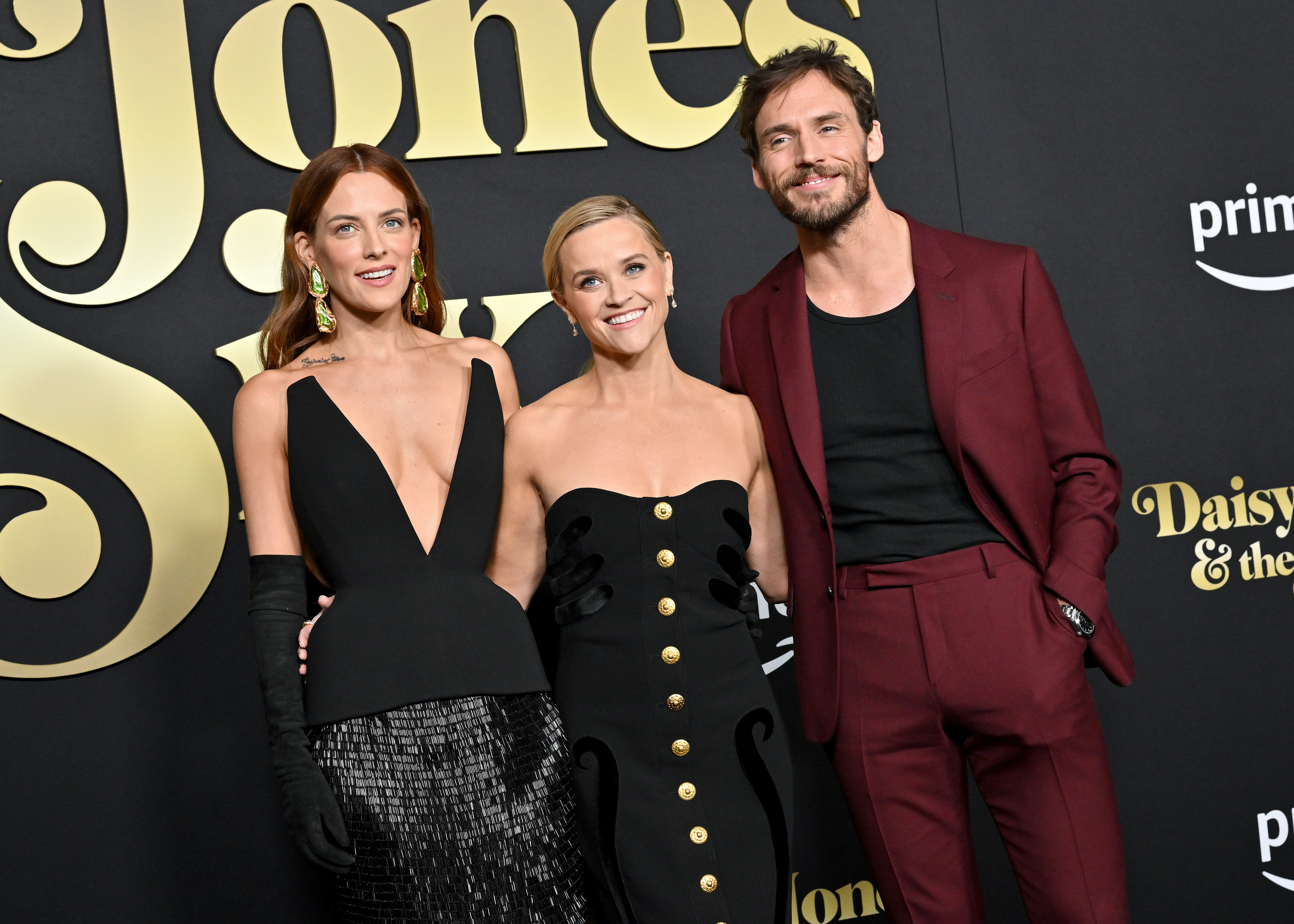 Sam Claflin with Riley Keough, and Reese Witherspoon at the Los Angeles Premiere of Prime Video's "Daisy Jones & The Six" in February 2023, in Hollywood, California. | Source: Getty Images.