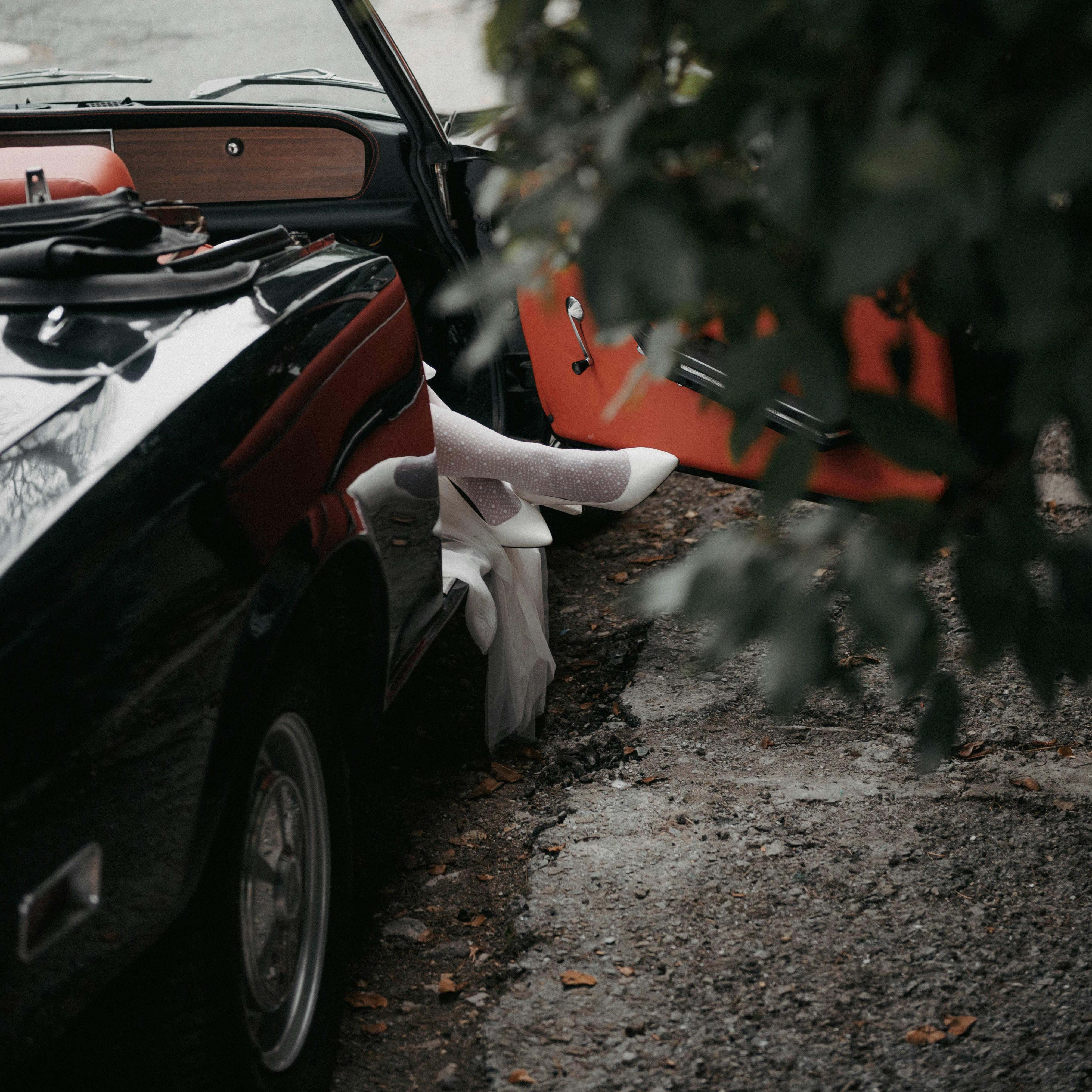 A woman stepping out of a car in a drive | Source: Pexels