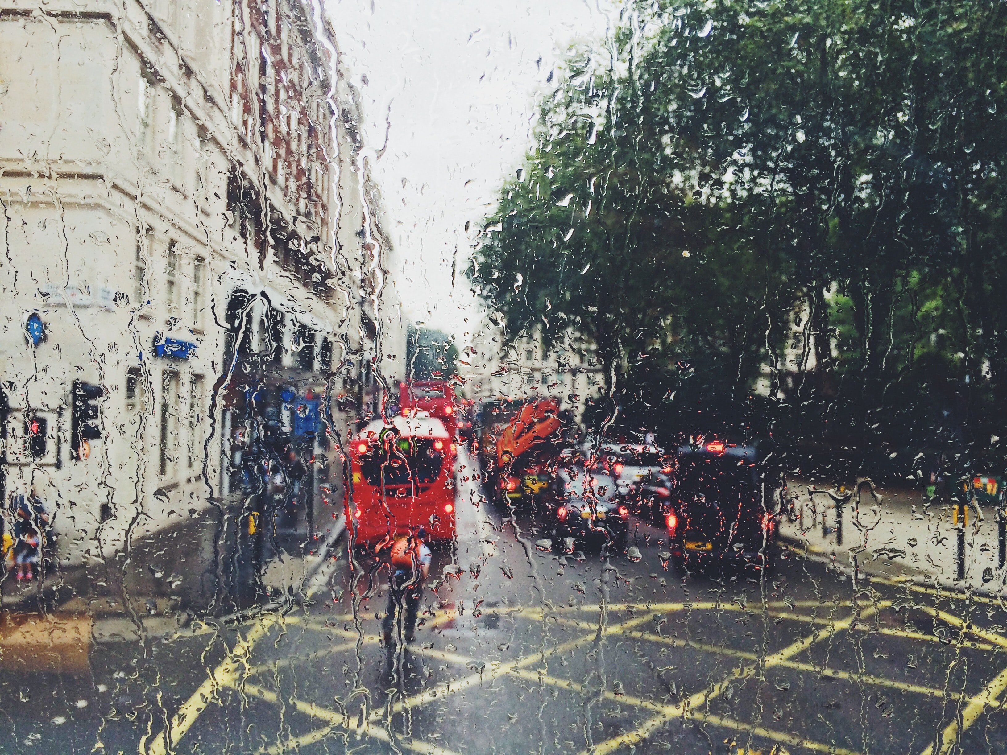 Red bus on a rainy street | Source: Unsplash