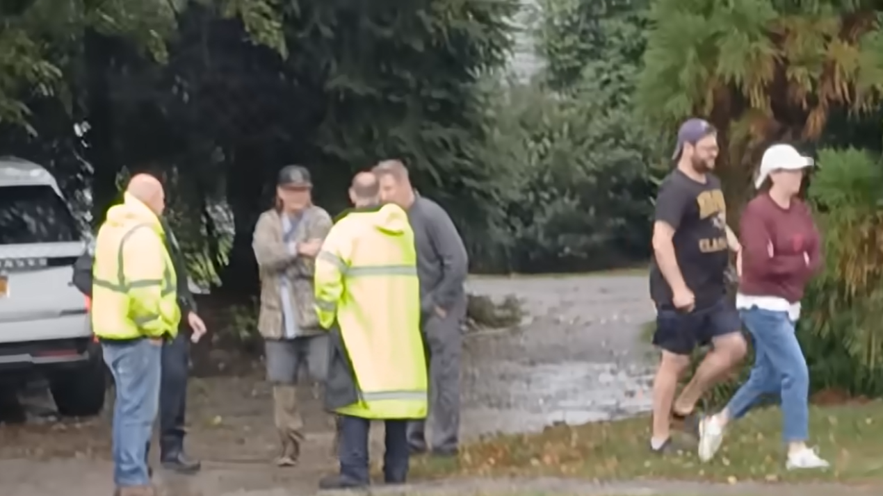 First responders and passersby are seen at the scene of the crash, seen in a video dated October 14, 2025 | Source: YouTube/@nypost