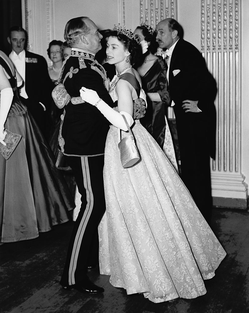 Queen Elizabeth II dancing with Air Marshal Sir John Baldwin, colonel of the 8th Hussars. | Source: Getty Images