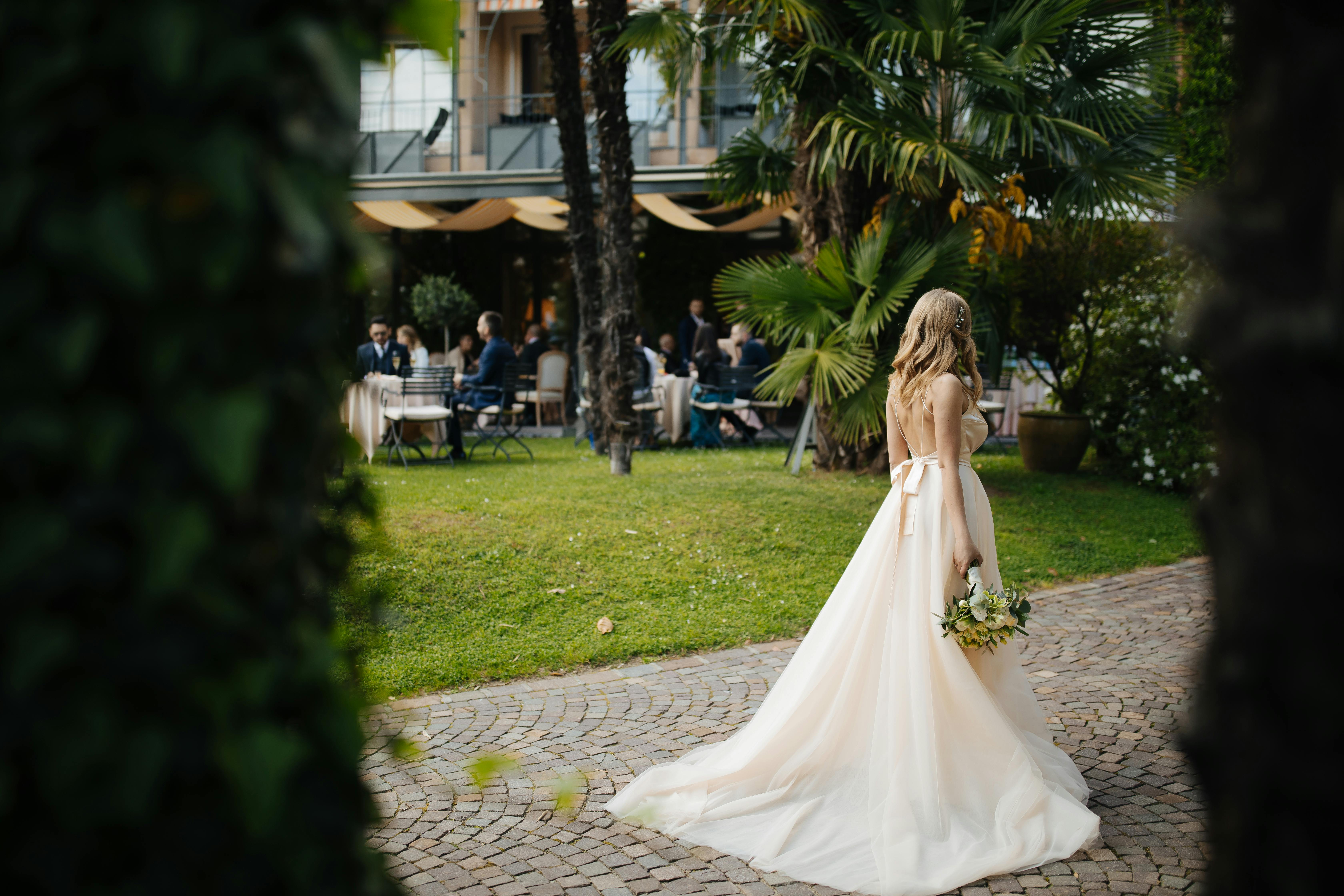 A bride holding a bouquet and walking alone during her wedding day | Source: Pexels