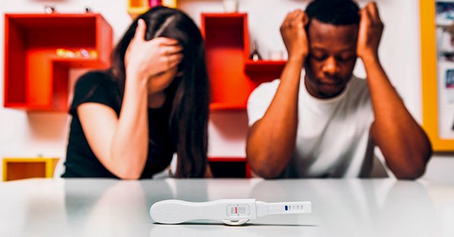 A man and woman looking at a pregnancy test. | Source: Shutterstock