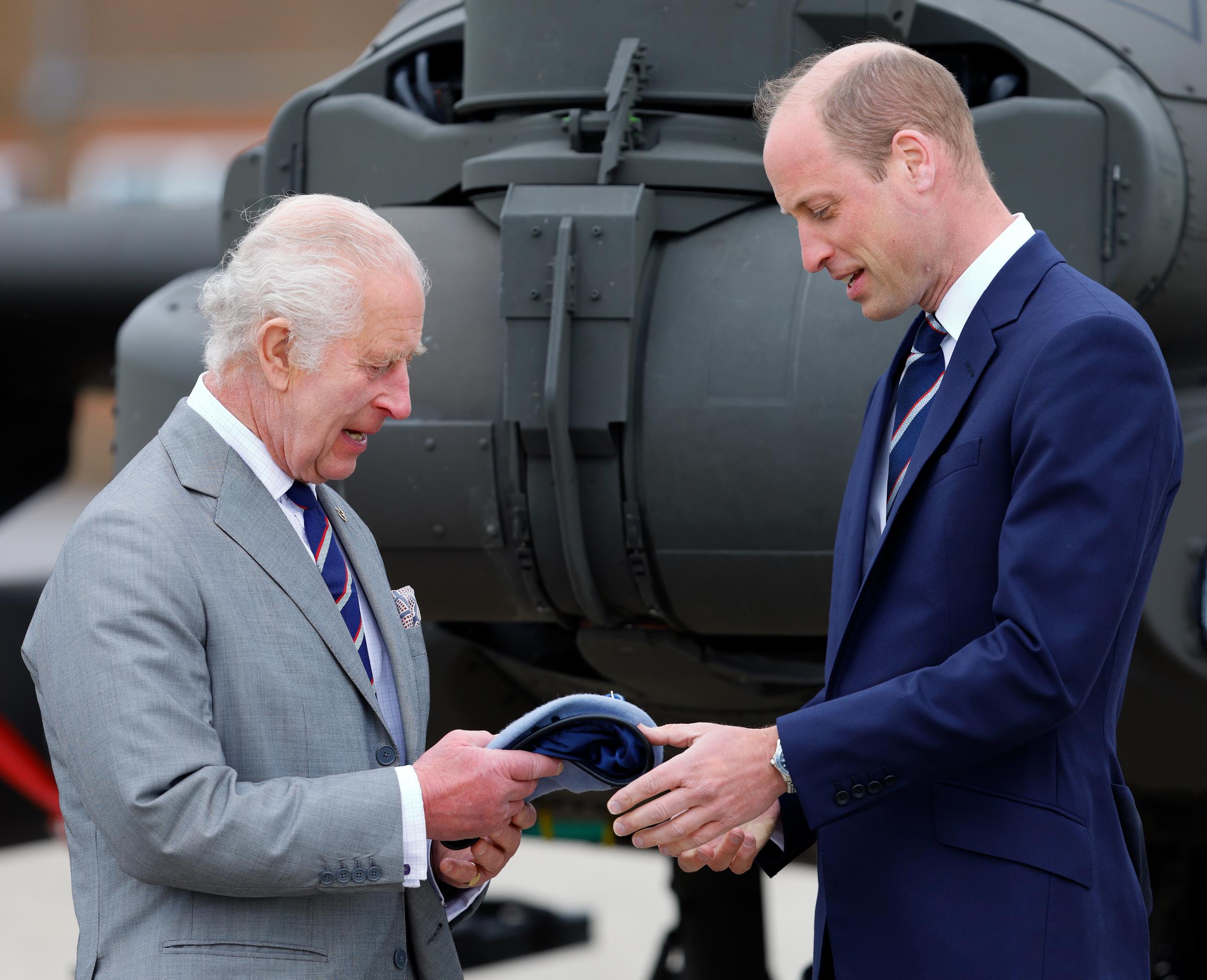 King Charles III hands Prince William the blue beret and belt of the Army Air Corps during a role handover in Middle Wallop, England, on May 13, 2024 | Source: Getty Images