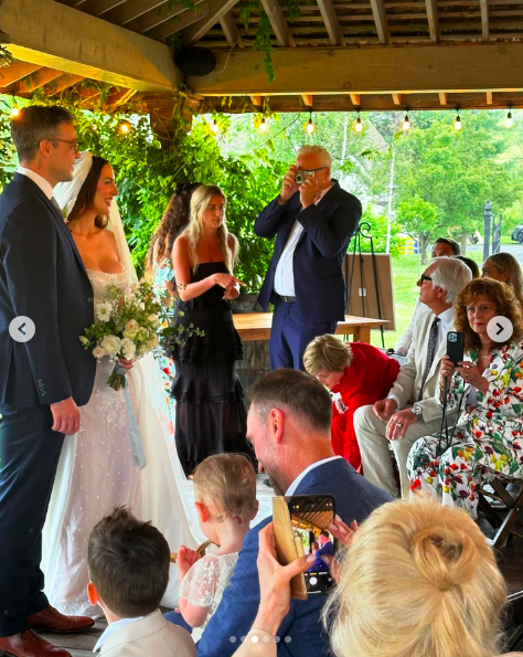 Ian Hock and Eva Amurri standing at the alter among guests, posted on July 1, 2024 | Source: Instagram/marcus.mcgregor