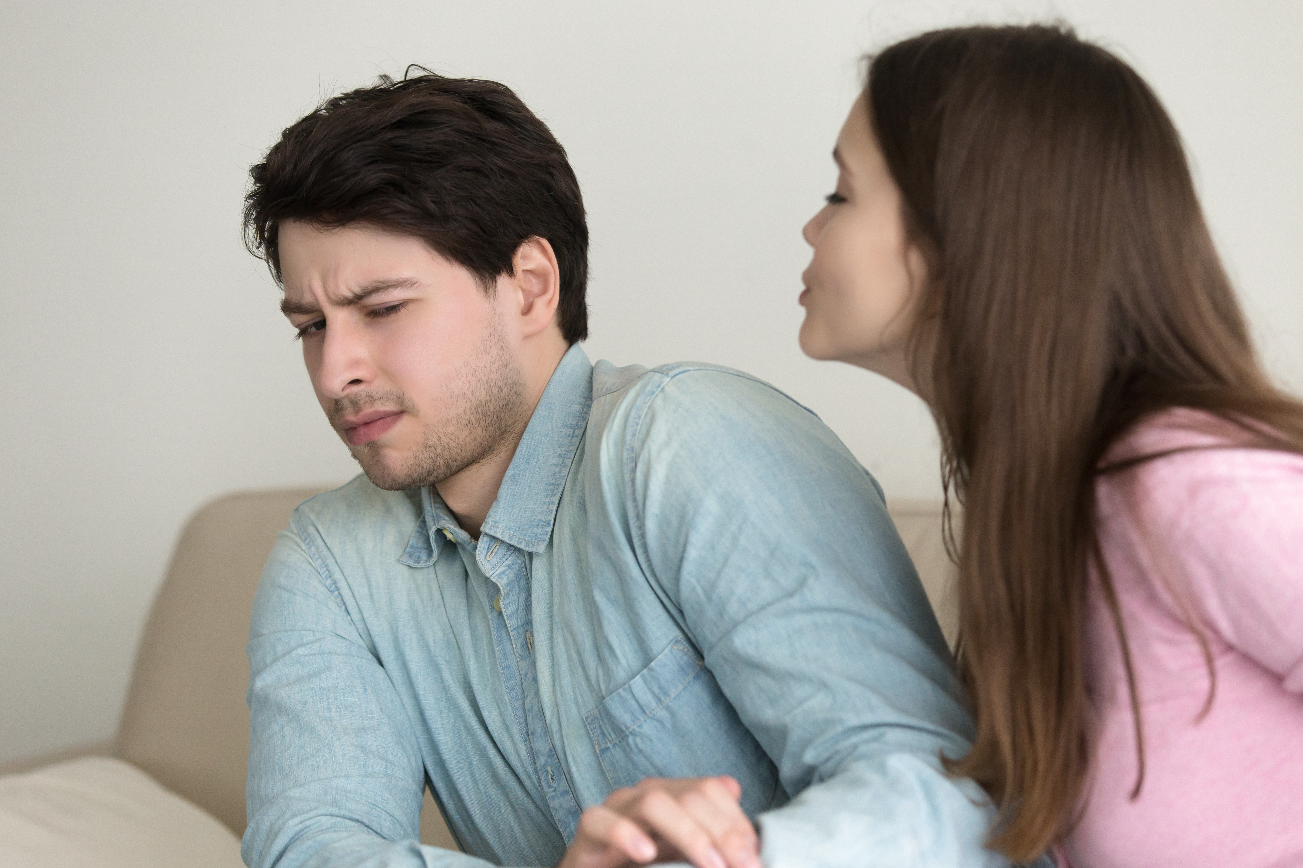 A man resisting his wife's kiss | Source: Shutterstock