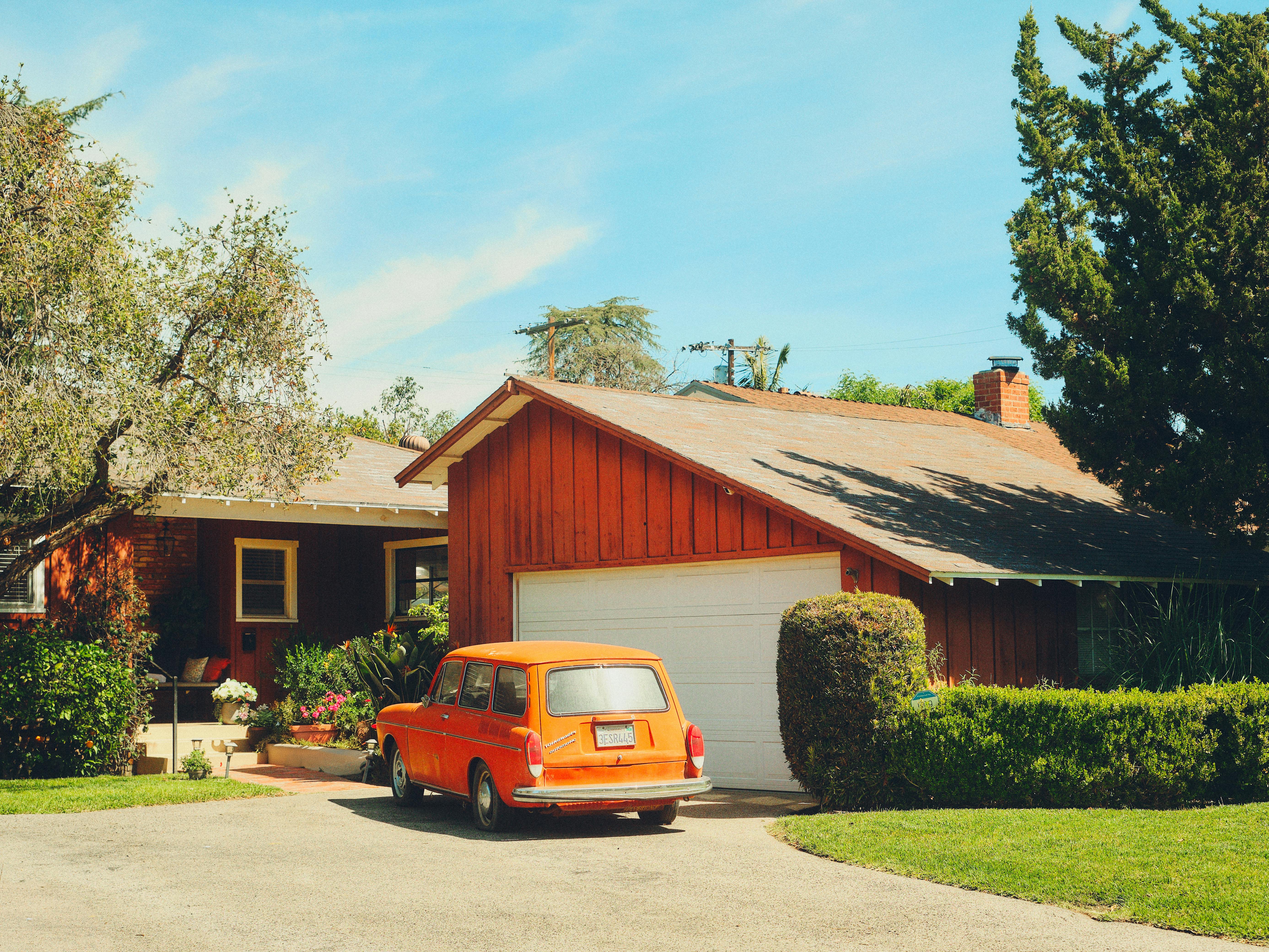 Car parked in the driveway of a modest home | Source: Pexels