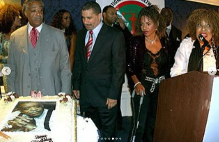 Al Sharpton stands beside a celebratory cake at an event honoring community leaders, surrounded by friends including Roberta Flack, posted on February 24, 2025 | Source: Instagram/real_sharpton