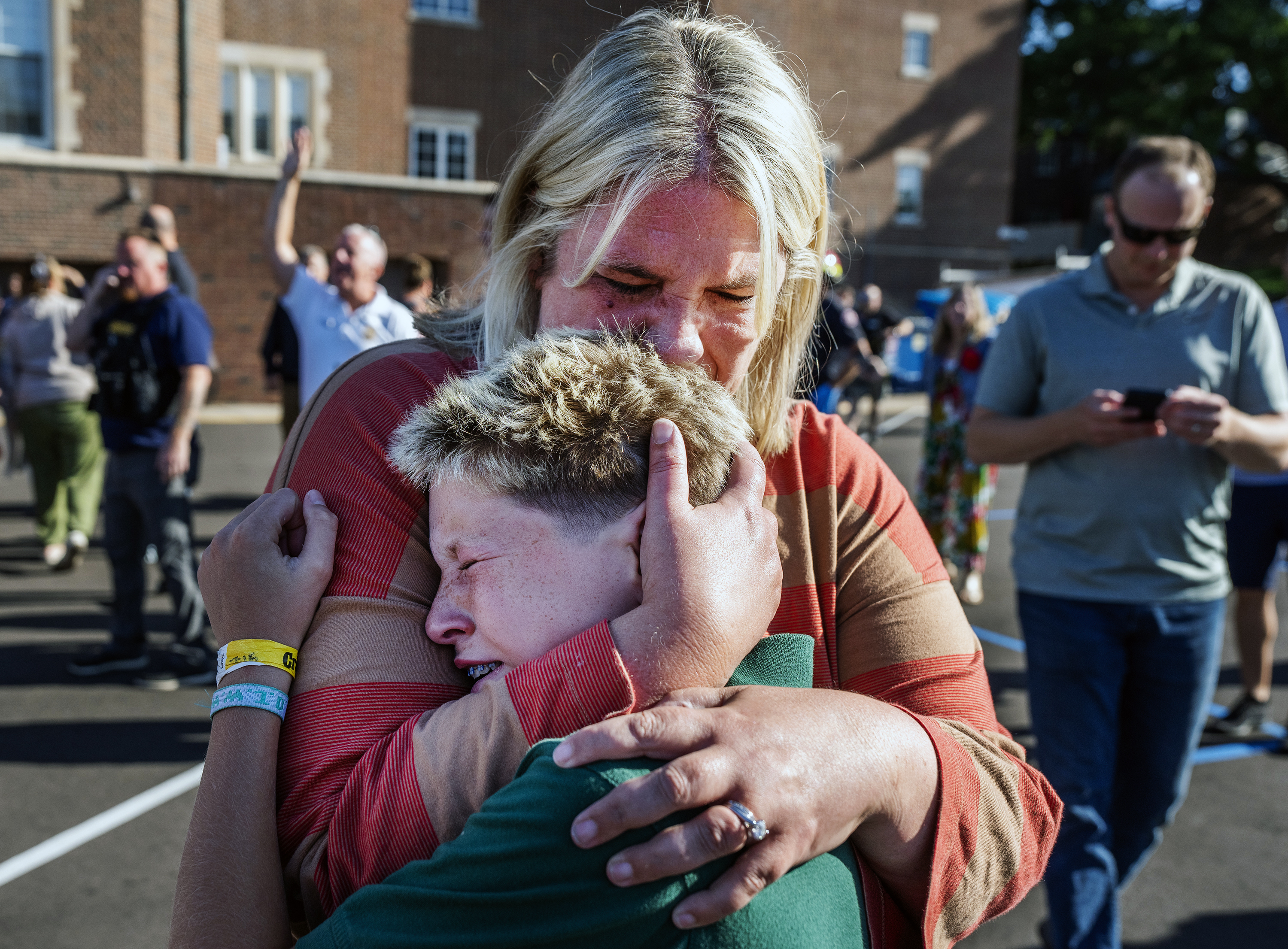 A woman embraces a child outside Annunciation Church after the shooting in Minneapolis on August 27, 2025 | Source: Getty Images