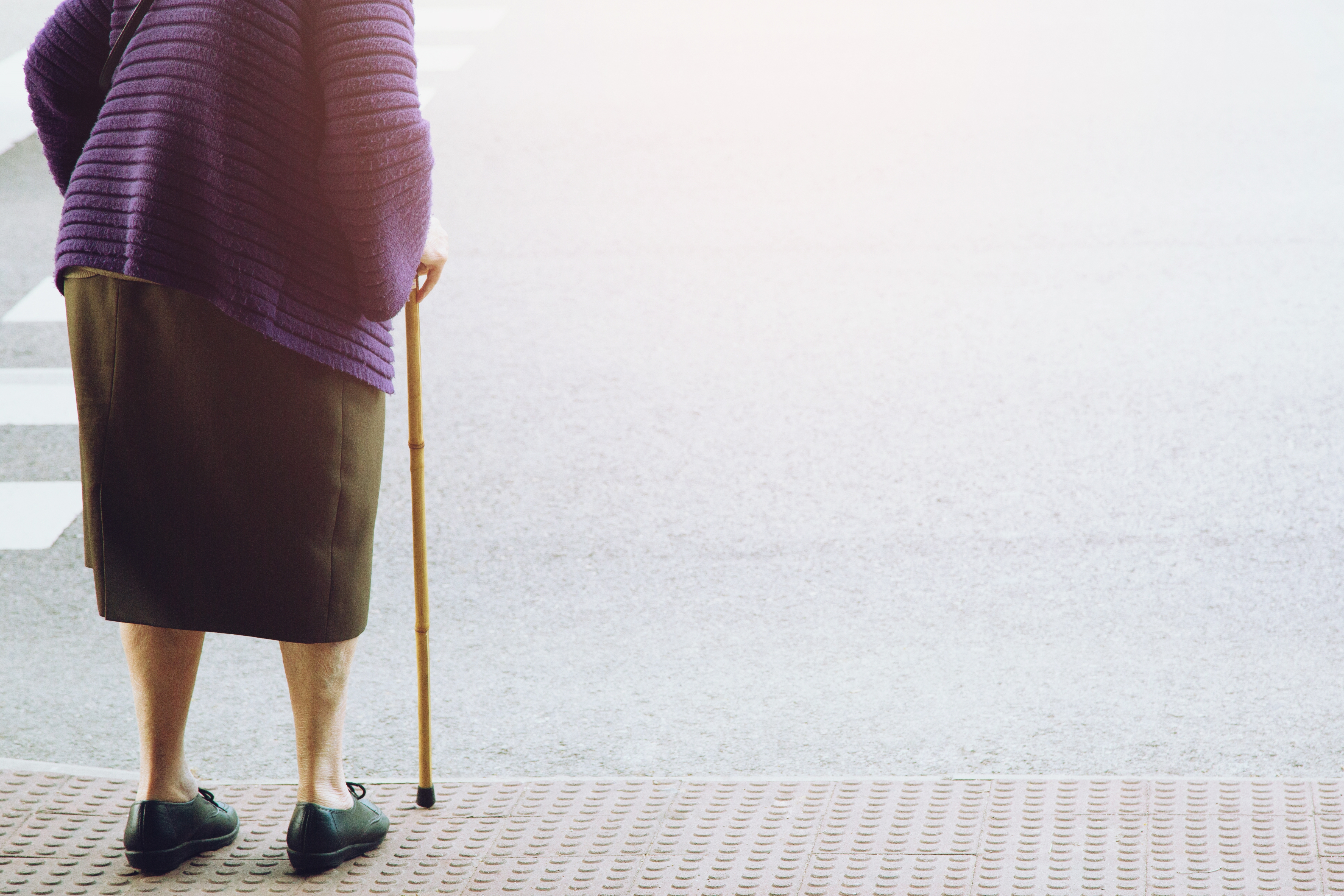 Elderly old woman crossing the street alone | Source: Shutterstock