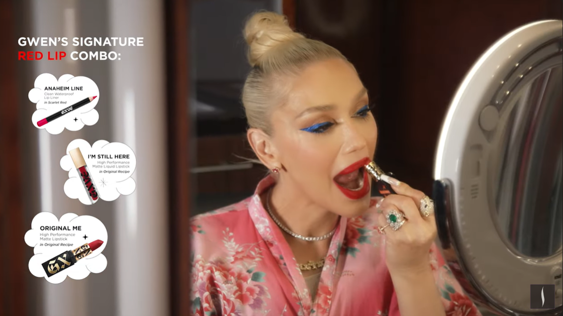 A screenshot showing Gwen Stefani applying her signature red lipstick in a Sephora tutorial video on April 23, 2024. | Source: YouTube/Sephora