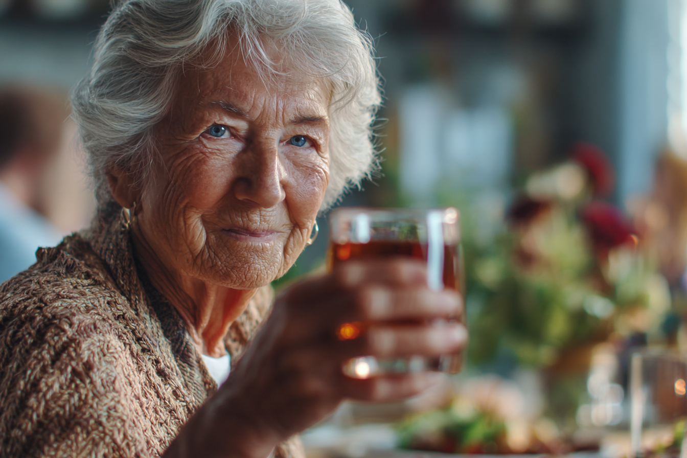 An older woman at a dinner table | Source: Midjourney