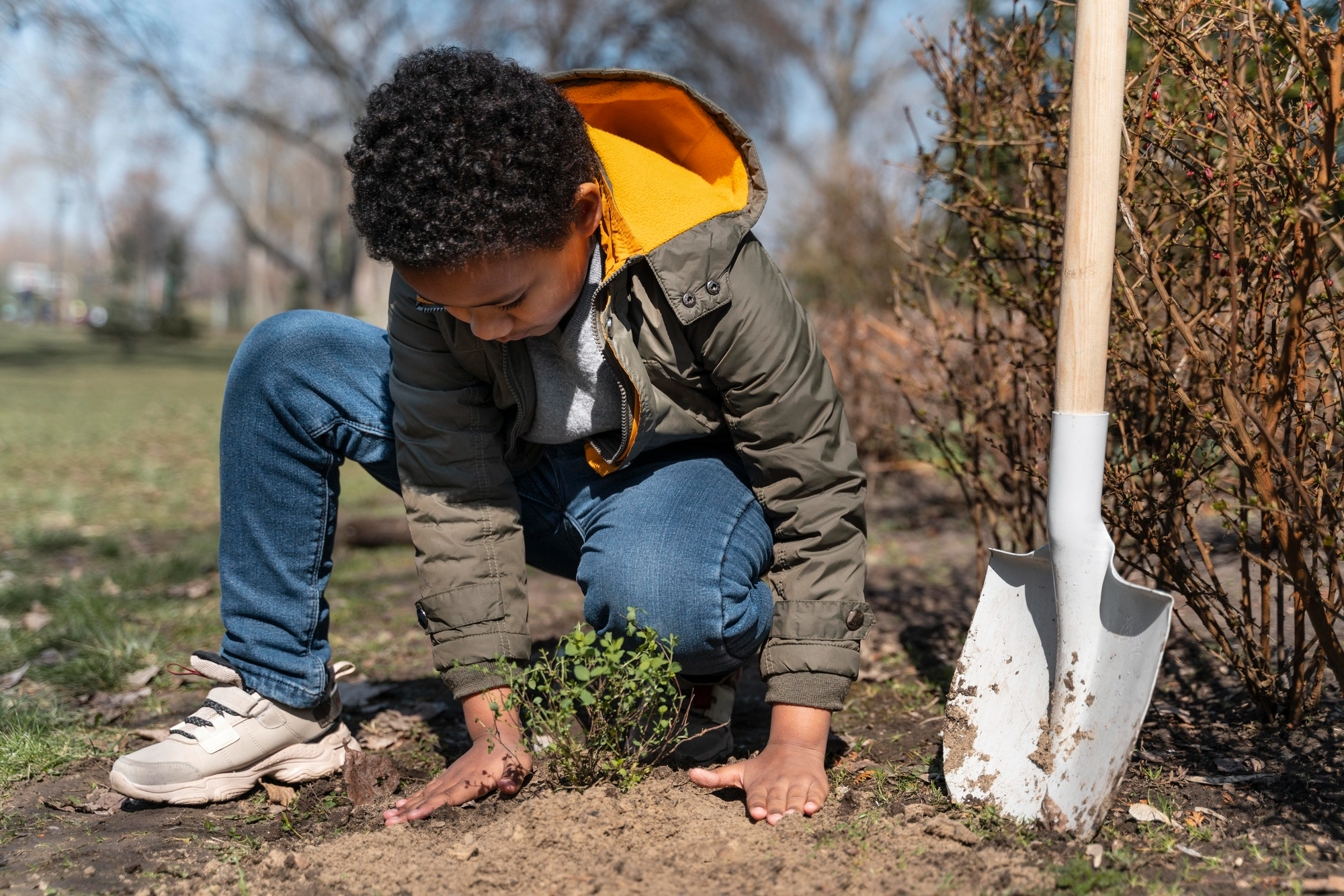 A young boy doing yard work | Source: Pexels