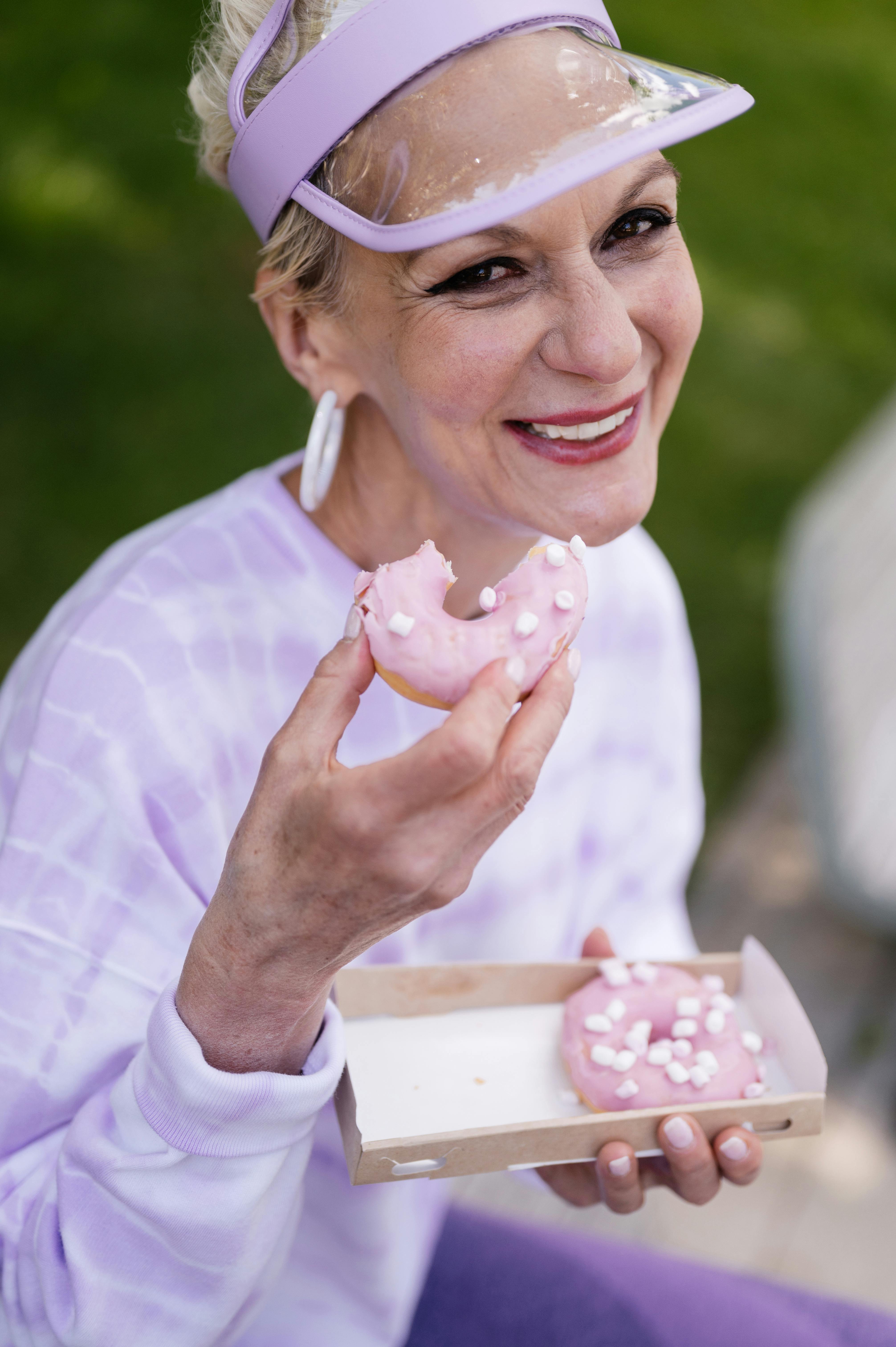 A woman enjoying some donuts | Source: Pexels