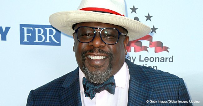 Cedric the Entertainer poses with wife and daughter who look stunning in tight dresses