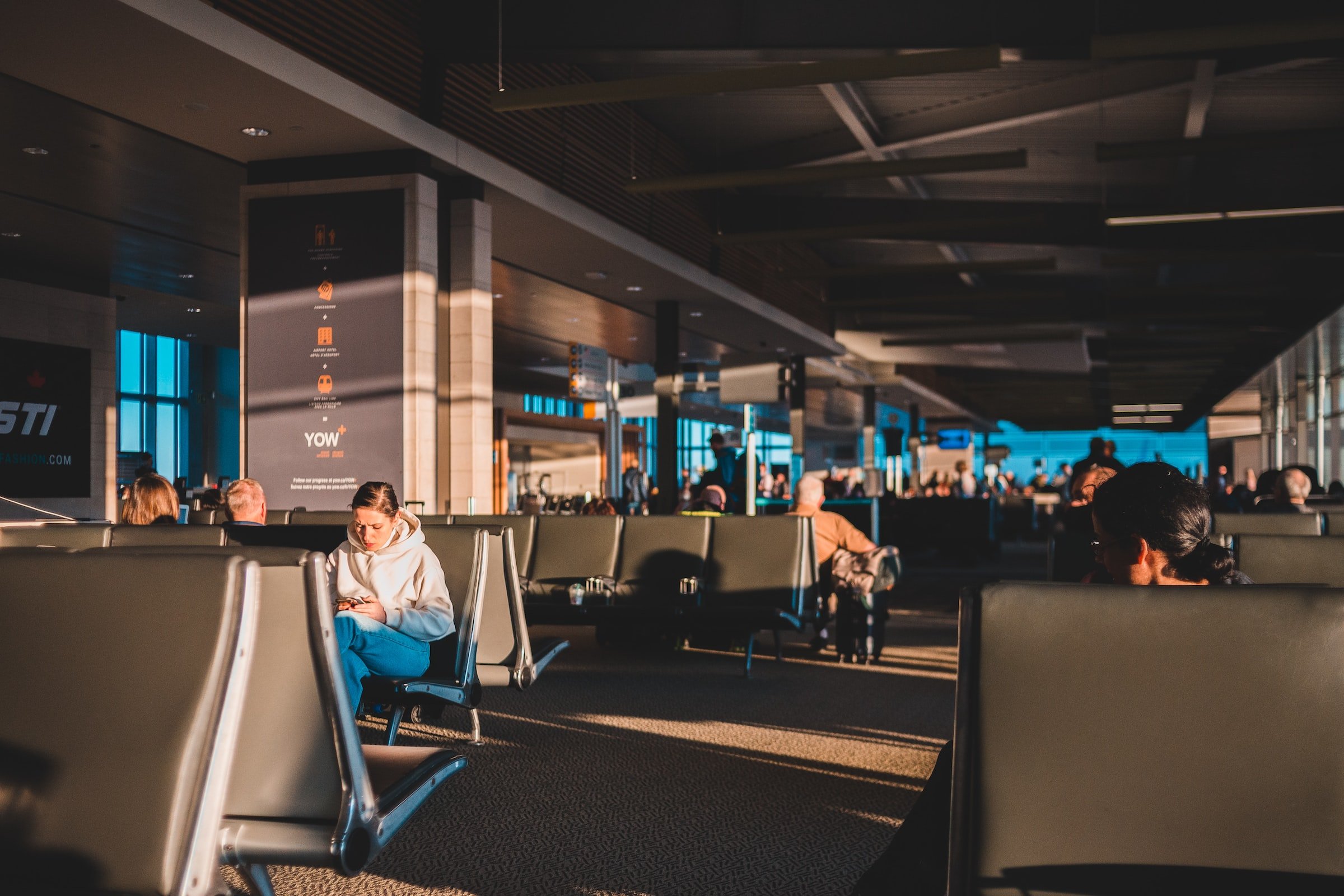 People sitting at an airport waiting lounge. | Source: Unsplash