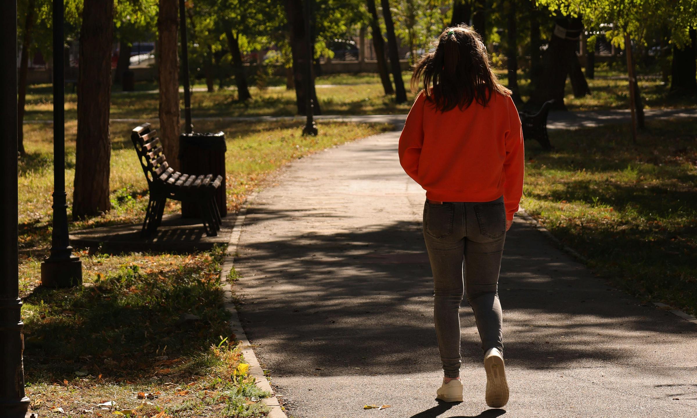 A woman walking away in a park | Source: Pexels