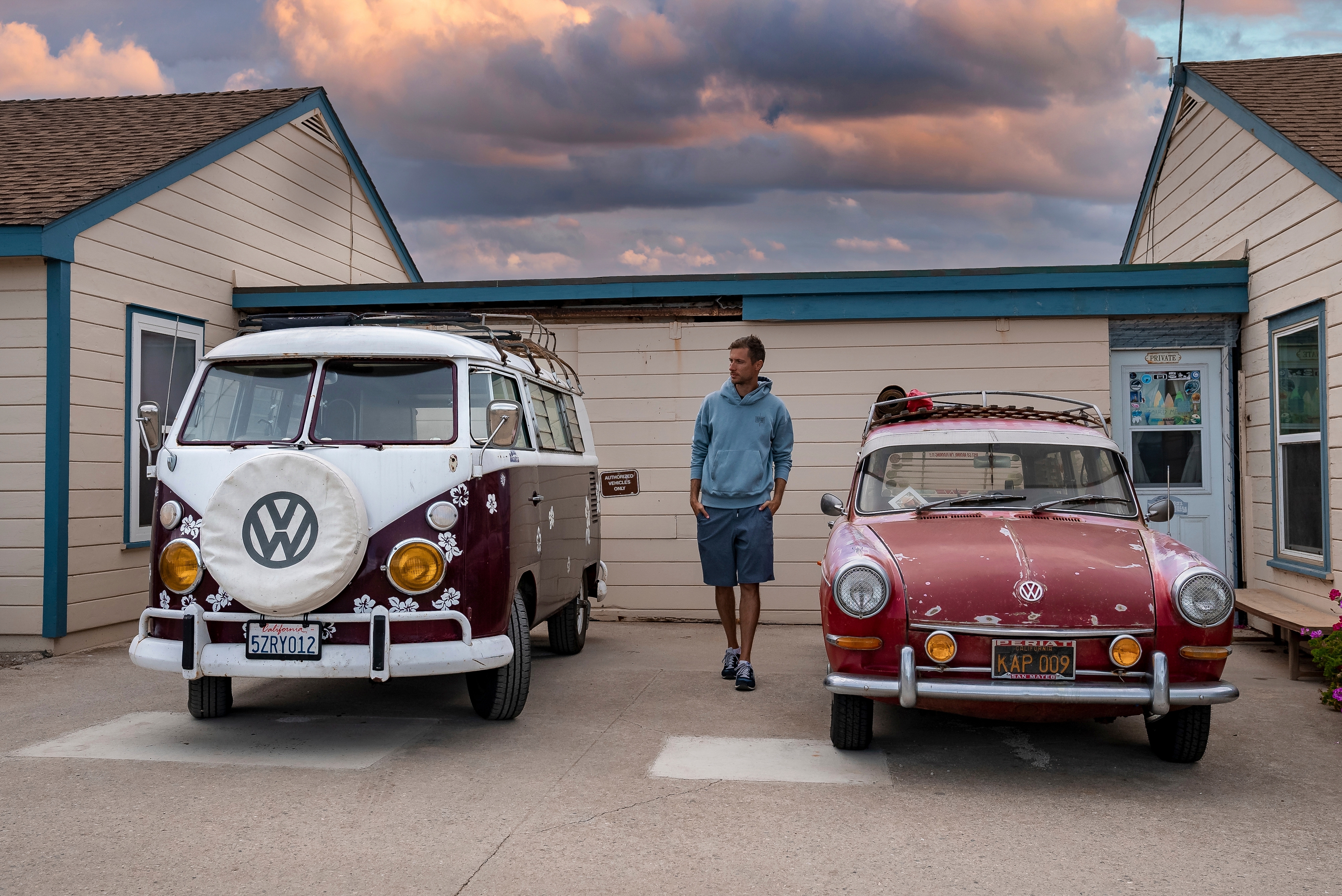 A man standing between vintage cars | Source: Shutterstock