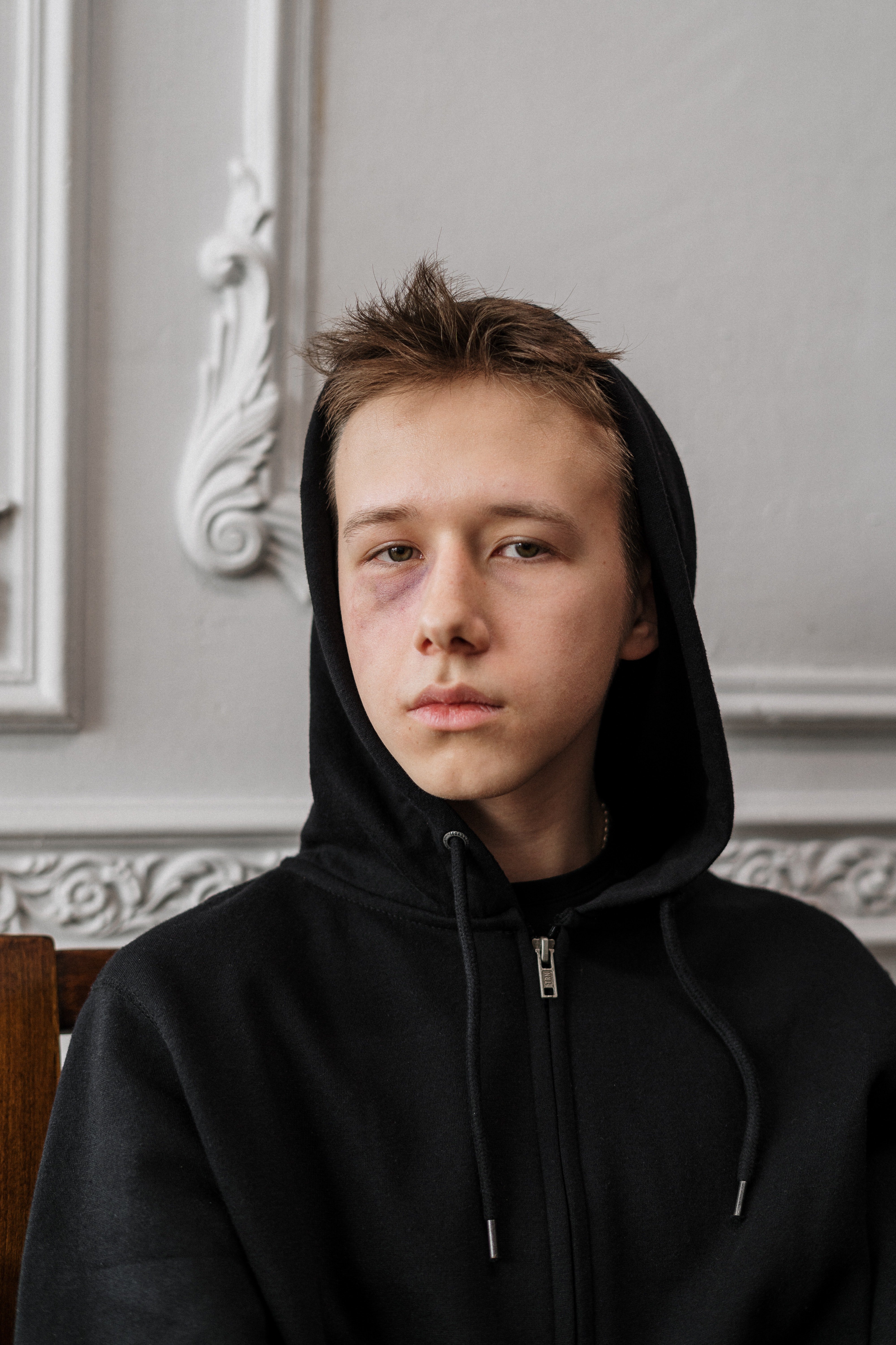 Sad boy in a black hoodie | Photo: Pexels