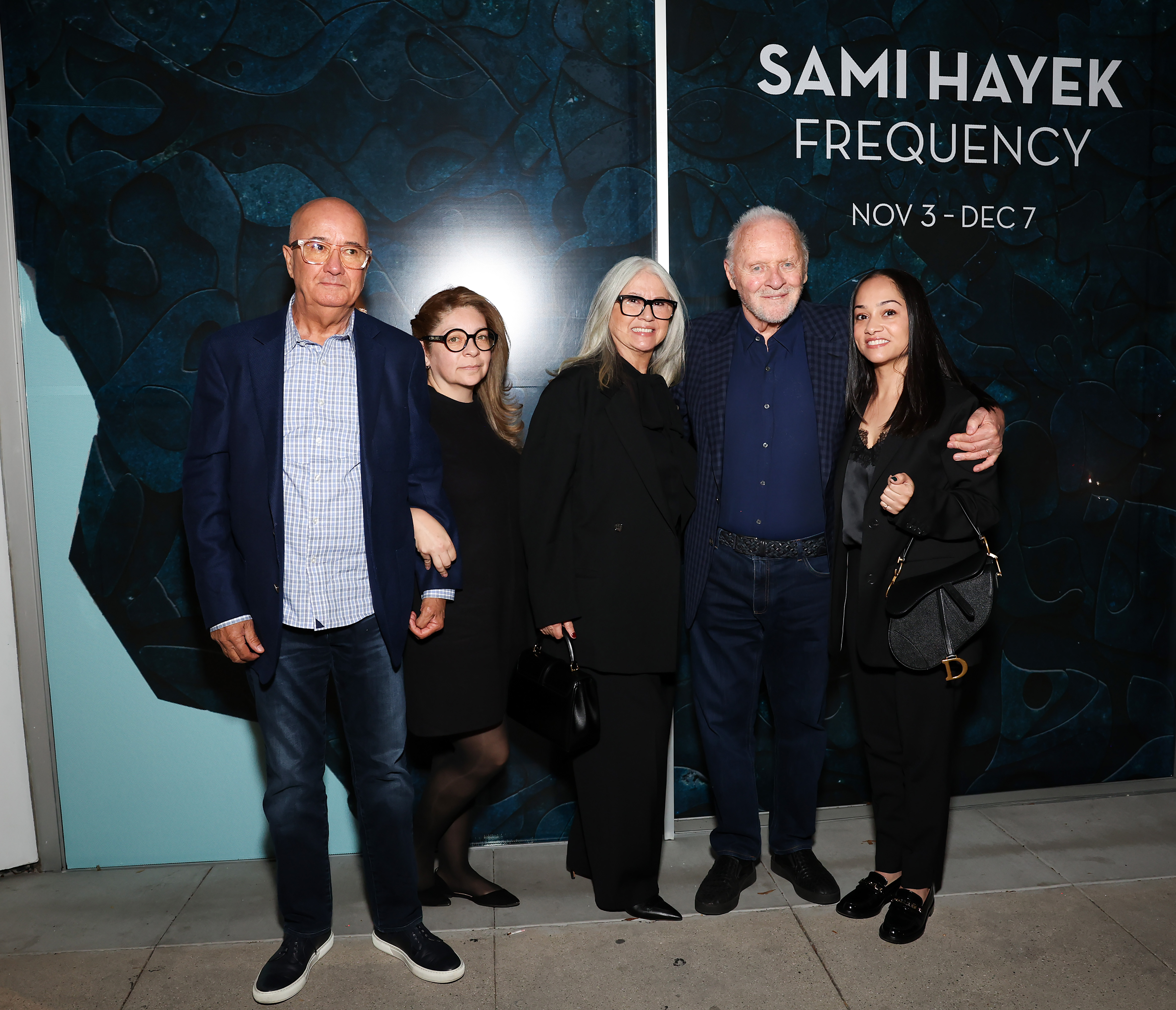 (3rd L-R) Stella Arroyave, Anthony Hopkins, and guests at the opening reception for Sami Hayek's art show, "Frequency" at Christie's Beverly Hills on November 2, 2023 in Beverly Hills, California