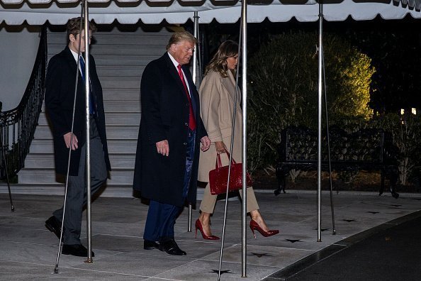 resident Donald Trump leaves the White House before departing for Joint Base Andrews on December 20, 2019 in Washington, DC. President Trump will sign S.1790, the "National Defense Authorization act for FY2020" at JBA before traveling to West Palm Beach, FL. Also pictured are First Lady Melania Trump and their son, Barron Trump | Photo: Getty Images