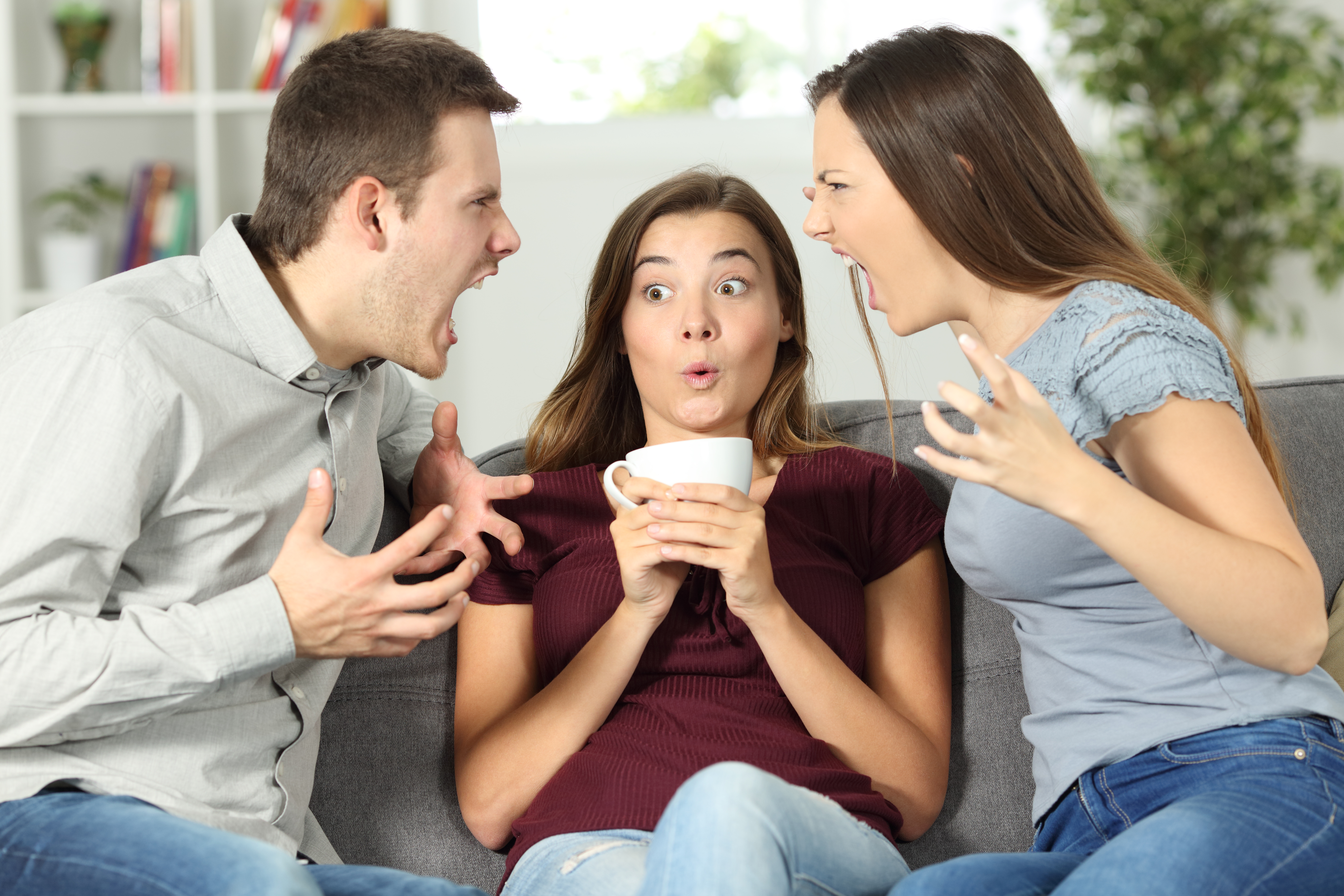 A couple and a mistress caught in an argument | Source: Getty Images