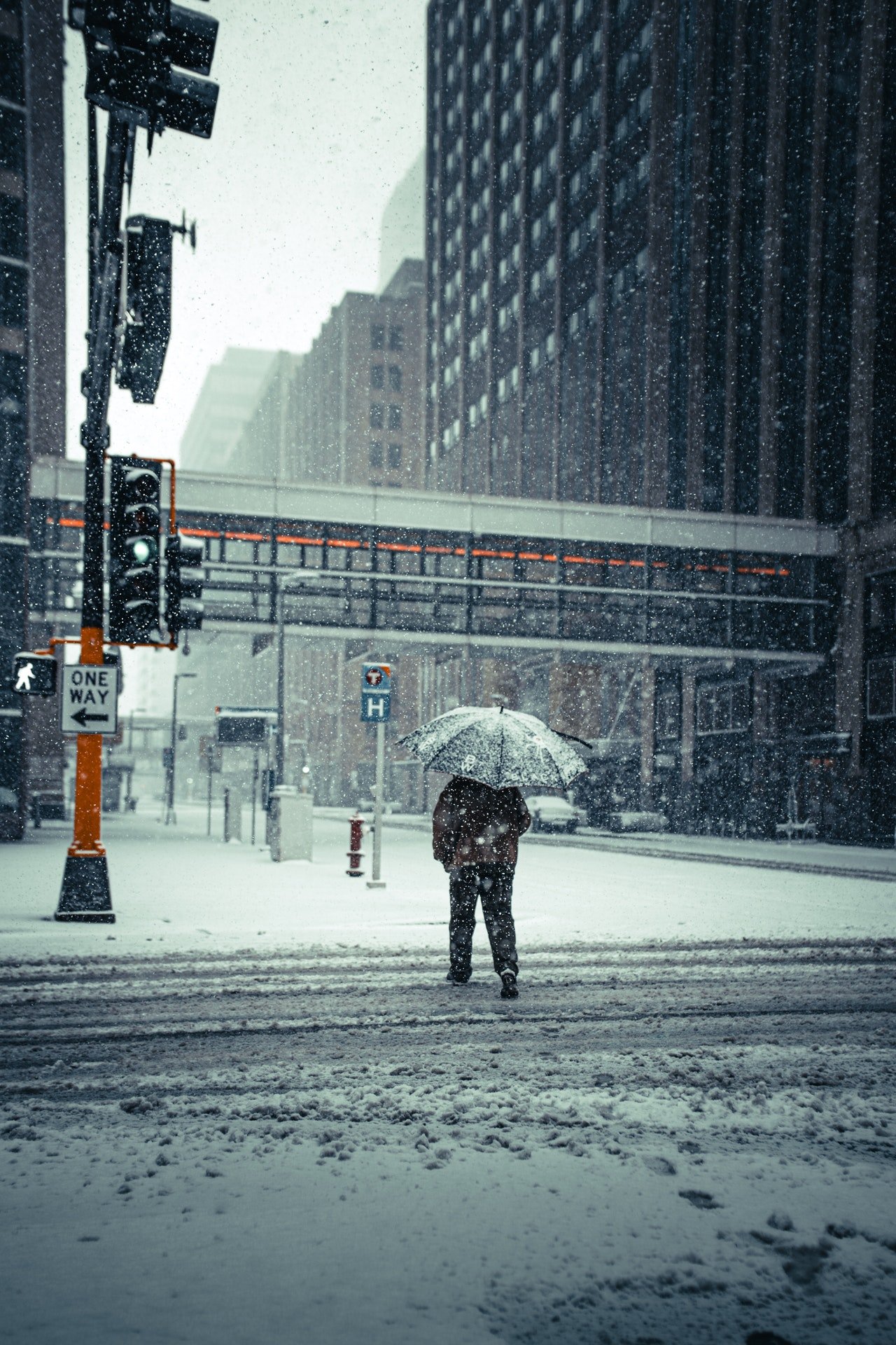 Photo of someone walking on a snowy street | Photo: Pexels