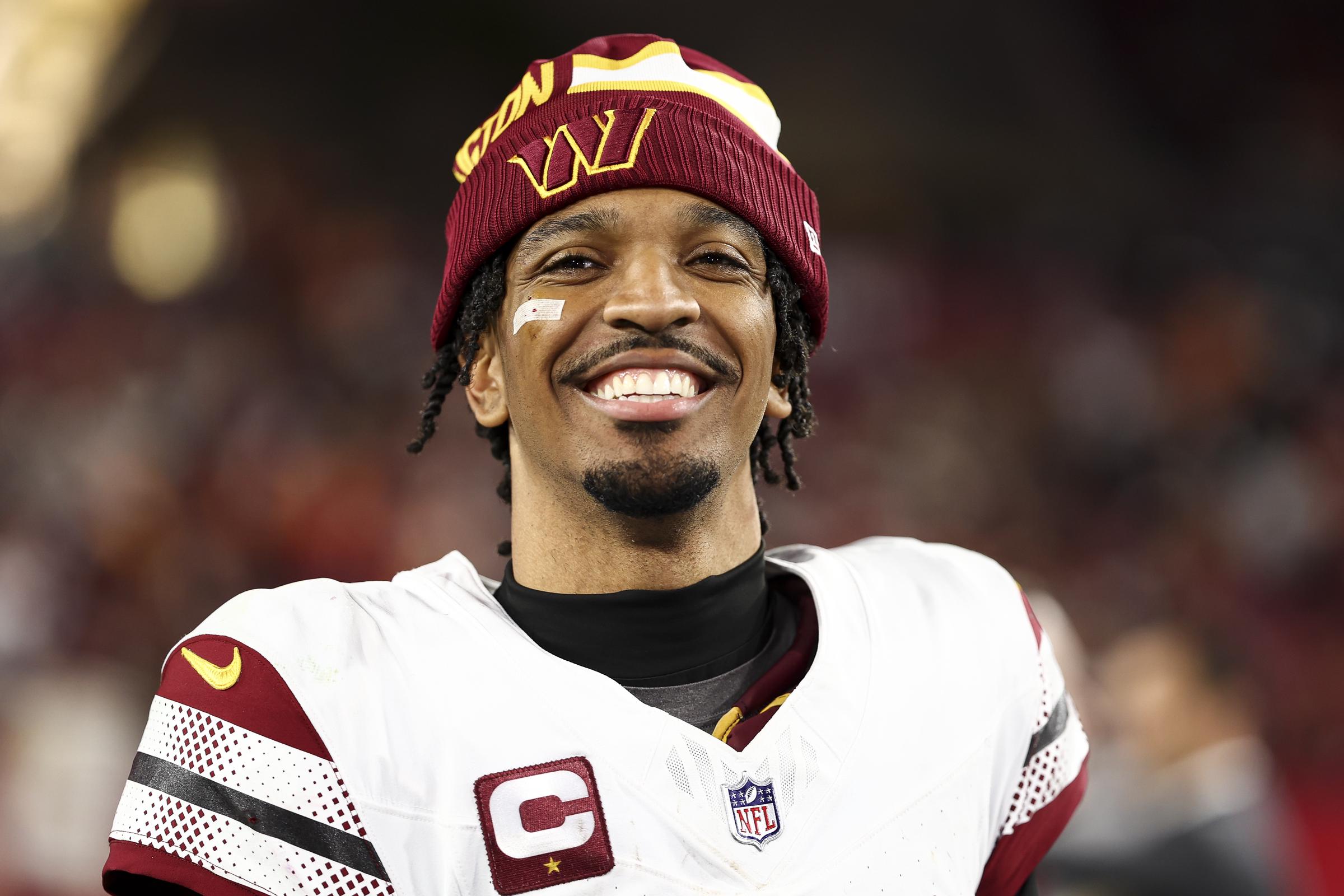 Jayden Daniels of the Washington Commanders smiles after an NFL football wild card playoff game against the Tampa Bay Buccaneers at Raymond James Stadium in Tampa, Florida, on January 12, 2025 | Source: Getty Images