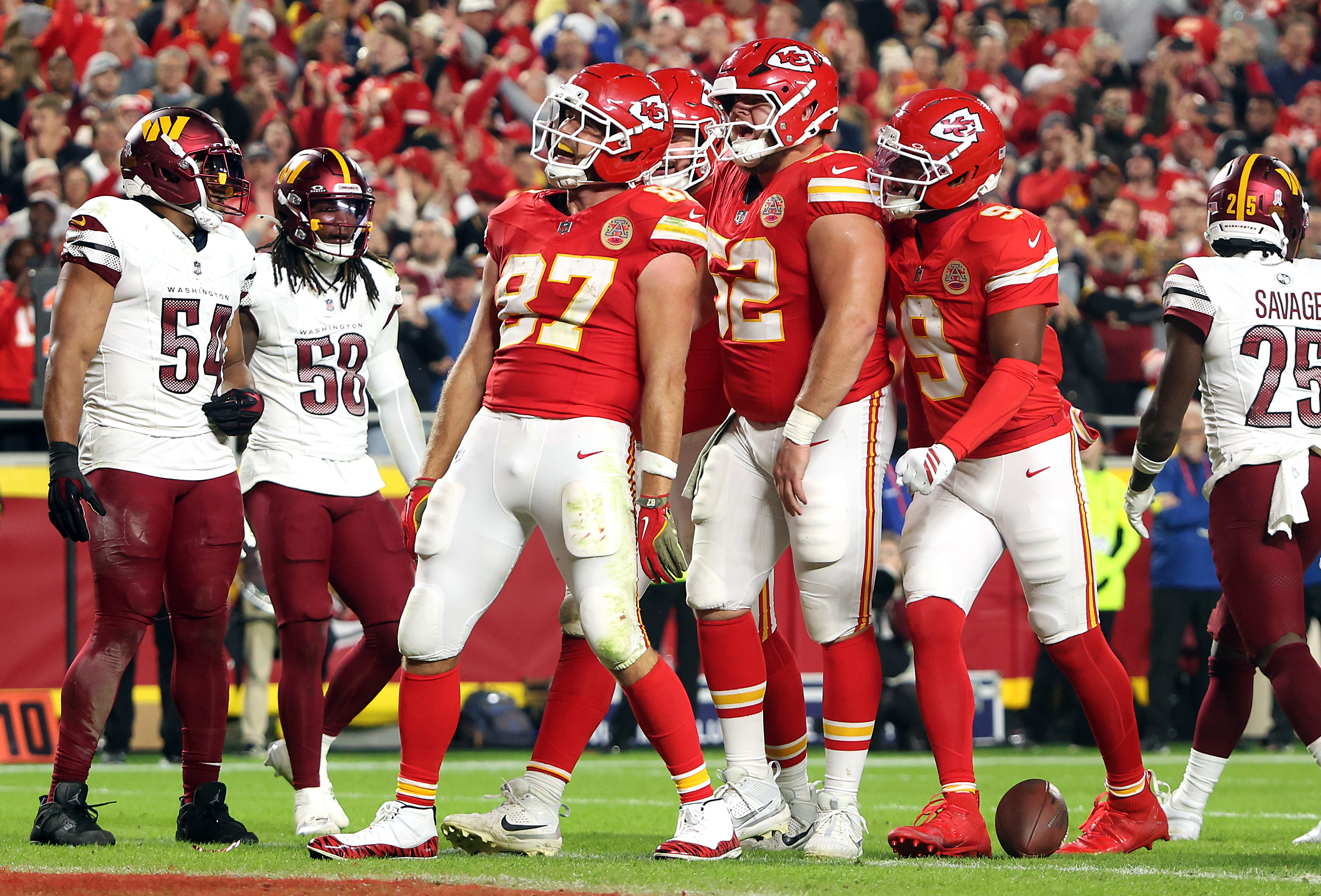 Some players of the Kansas City Chiefs celebrating as players from the Washington Commanders look on. | Source: Getty Images