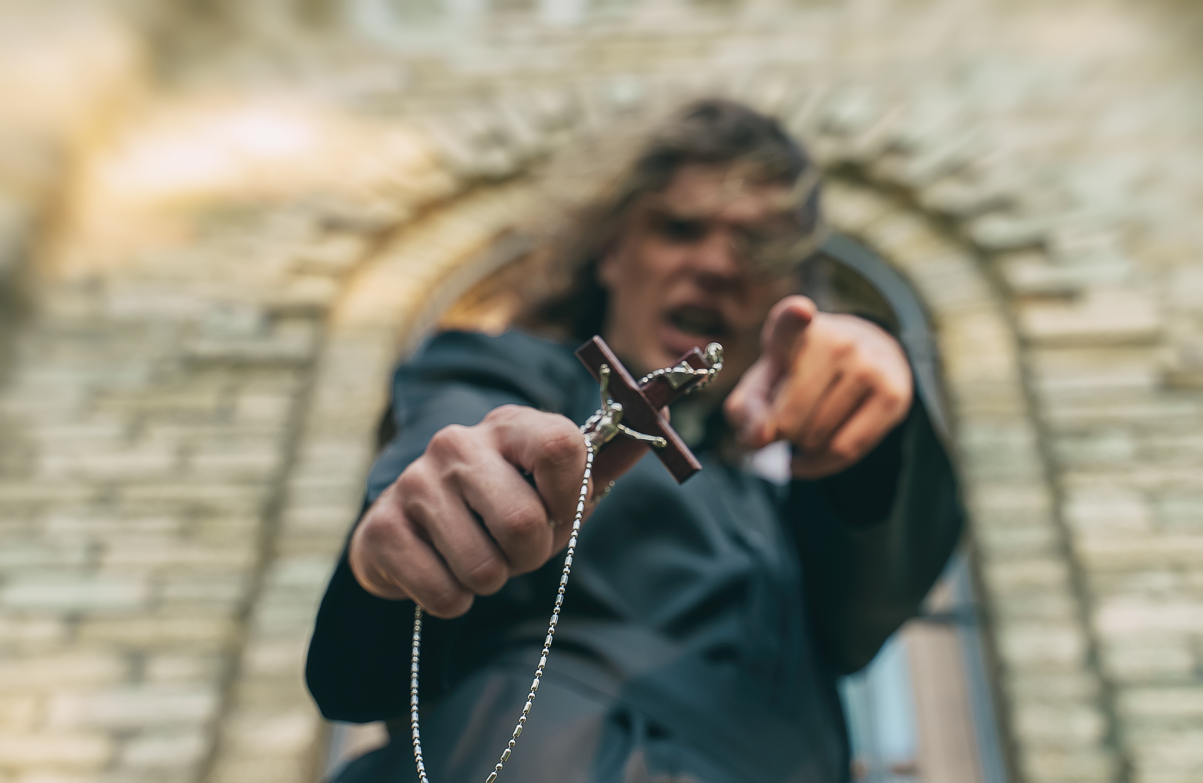 A Christian priest giving a sermon with a crucifix | Source: Shutterstock