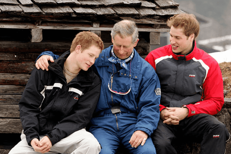 Prince Charles hugs his son Prince Harry while joined by Prince William during a holiday at Klosters on March 31, 2005, Switzerland | Source: Pascal Le Segretain/Getty Images
