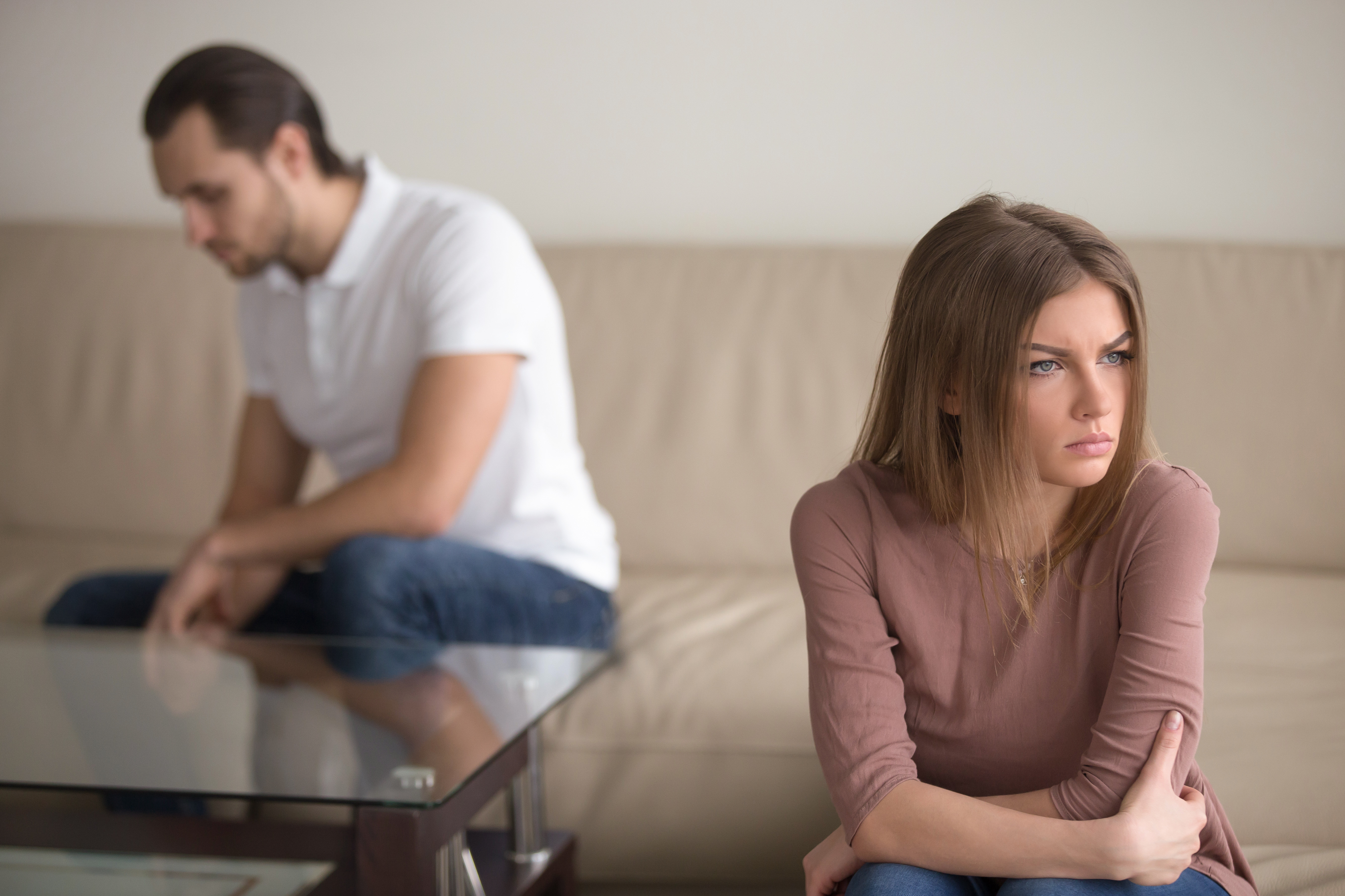 A couple sitting apart after an argument | Source: Shutterstock
