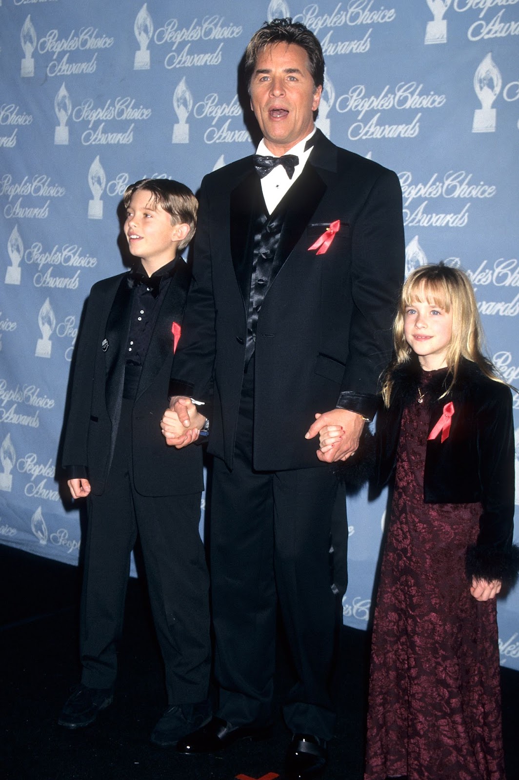 Don Johnson with Melanie Griffith's son Alexander Bauer and his daughter Dakota Johnson at the 23rd Annual People's Choice Awards on January 12, 1997, in Santa Monica, California. | Source: Getty Images