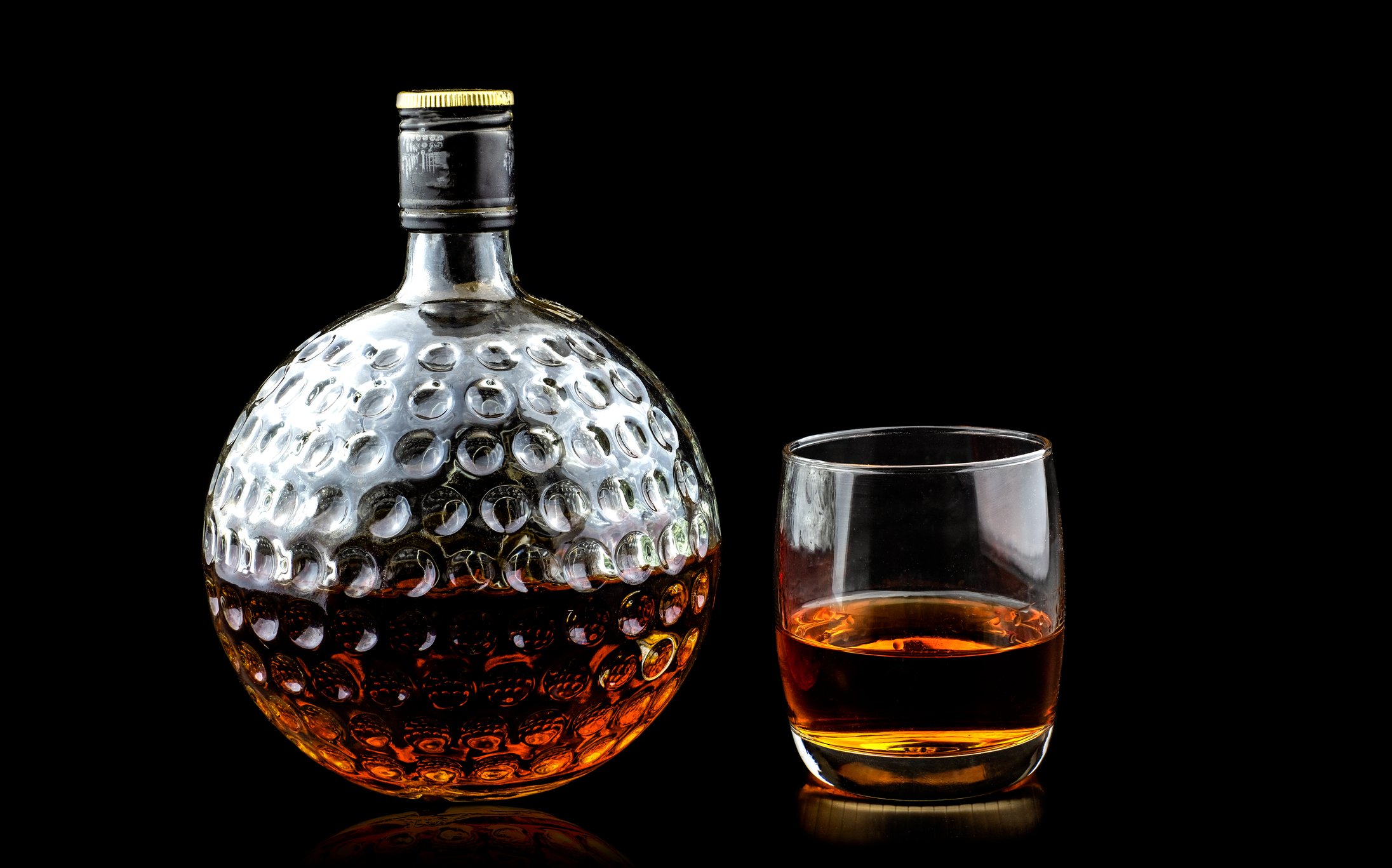 A portrait of a bottle of whisky and a glass. | Photo: Getty Images