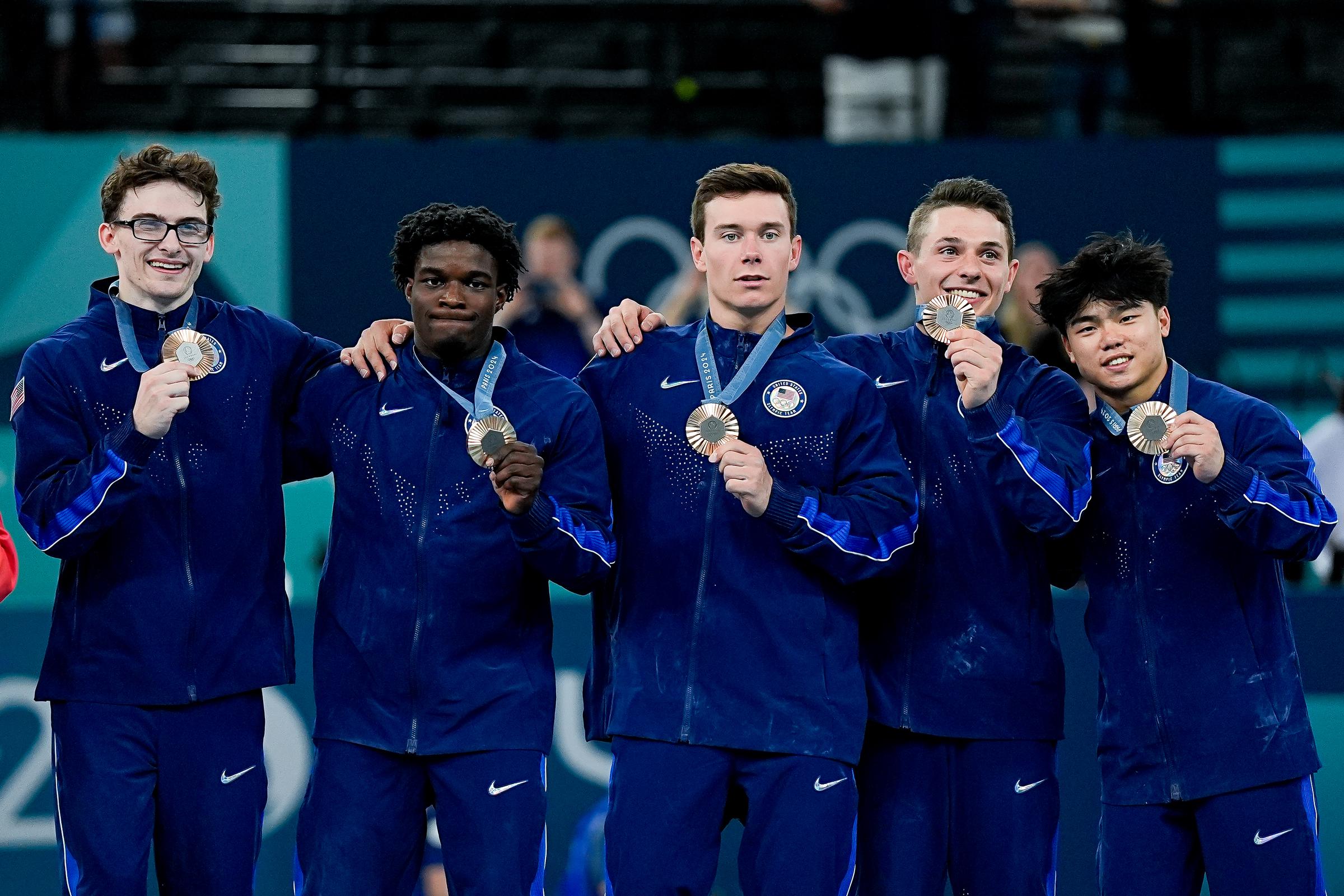 Stephen Nedoroscik, Frederick Richard, Brody Malone, Paul Juda, and Asher Hong of Team USA pose with their bronze medals after the Men's Artistic Gymnastics Team Final at the Paris 2024 Olympics on July 29, 2024 | Source: Getty Images