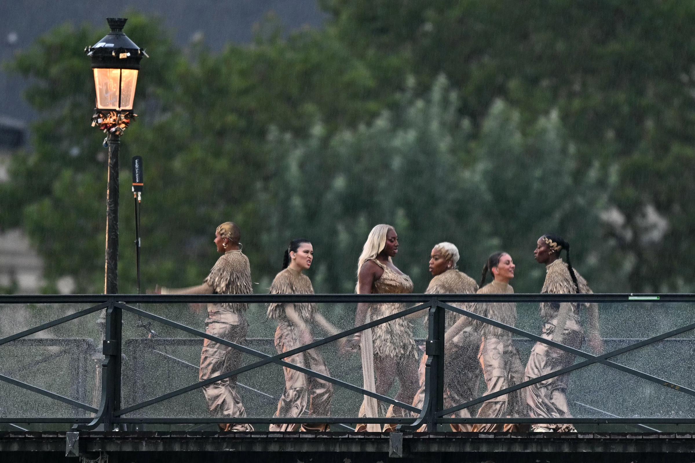 Aya Nakamura (C) and dancers perfom on the Pont des Arts footbridge during the opening ceremony of the Paris 2024 Olympic Games in Paris, France, on July 26, 2024. | Source: Getty Images