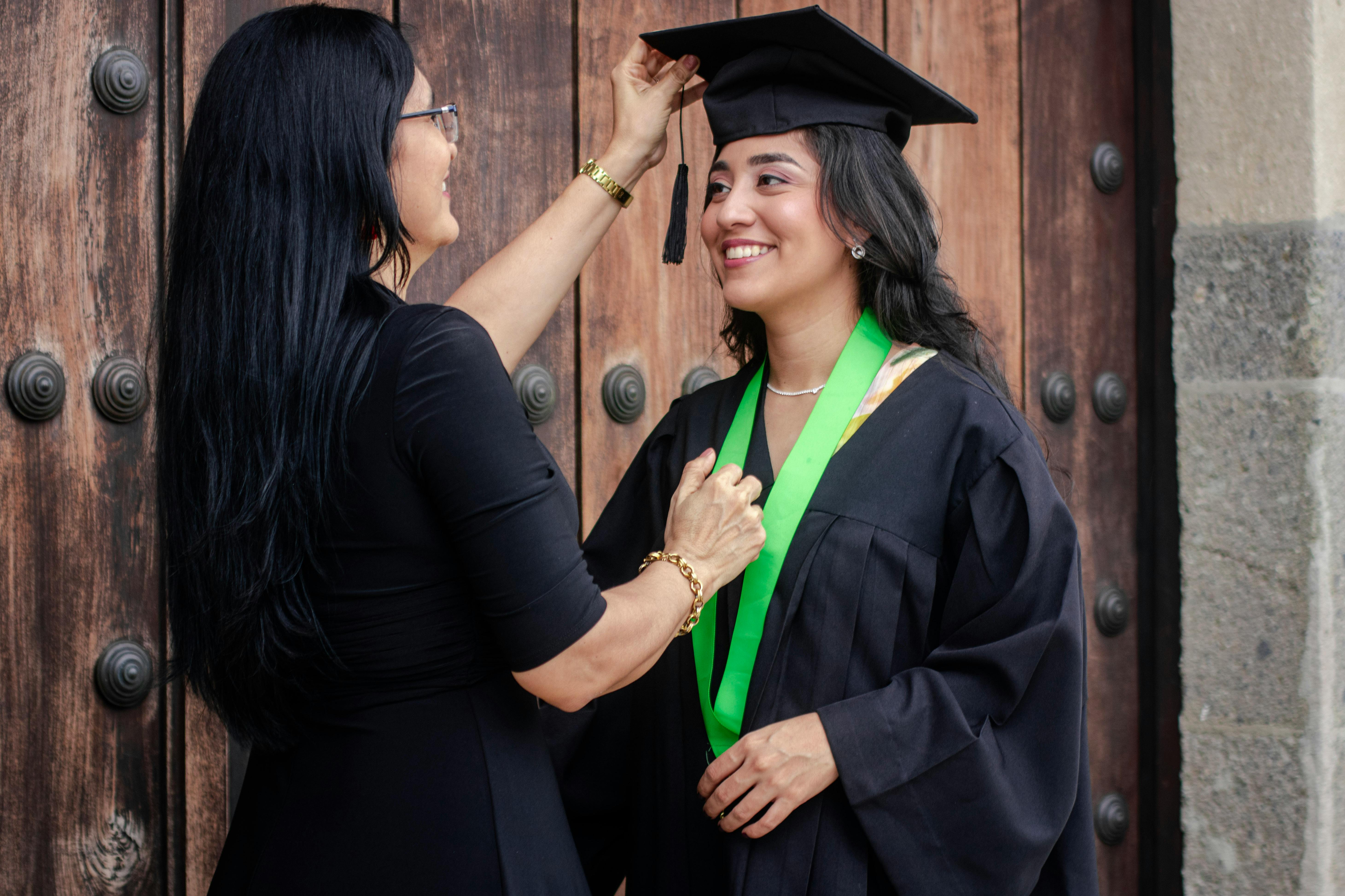 An older woman celebrating a young one's college graduation | Source: Pexels